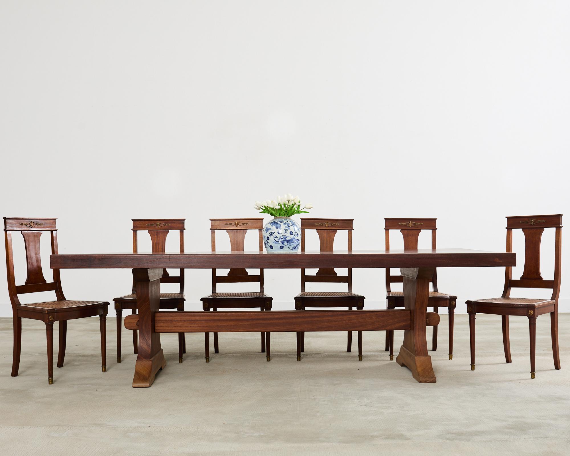 Spectacular country French farmhouse dining table featuring an exotic African mahogany hardwood construction. Very rare to find a European trestle table crafted from exotic hardwood in this size and scale. The table is deceptively heavy and solid