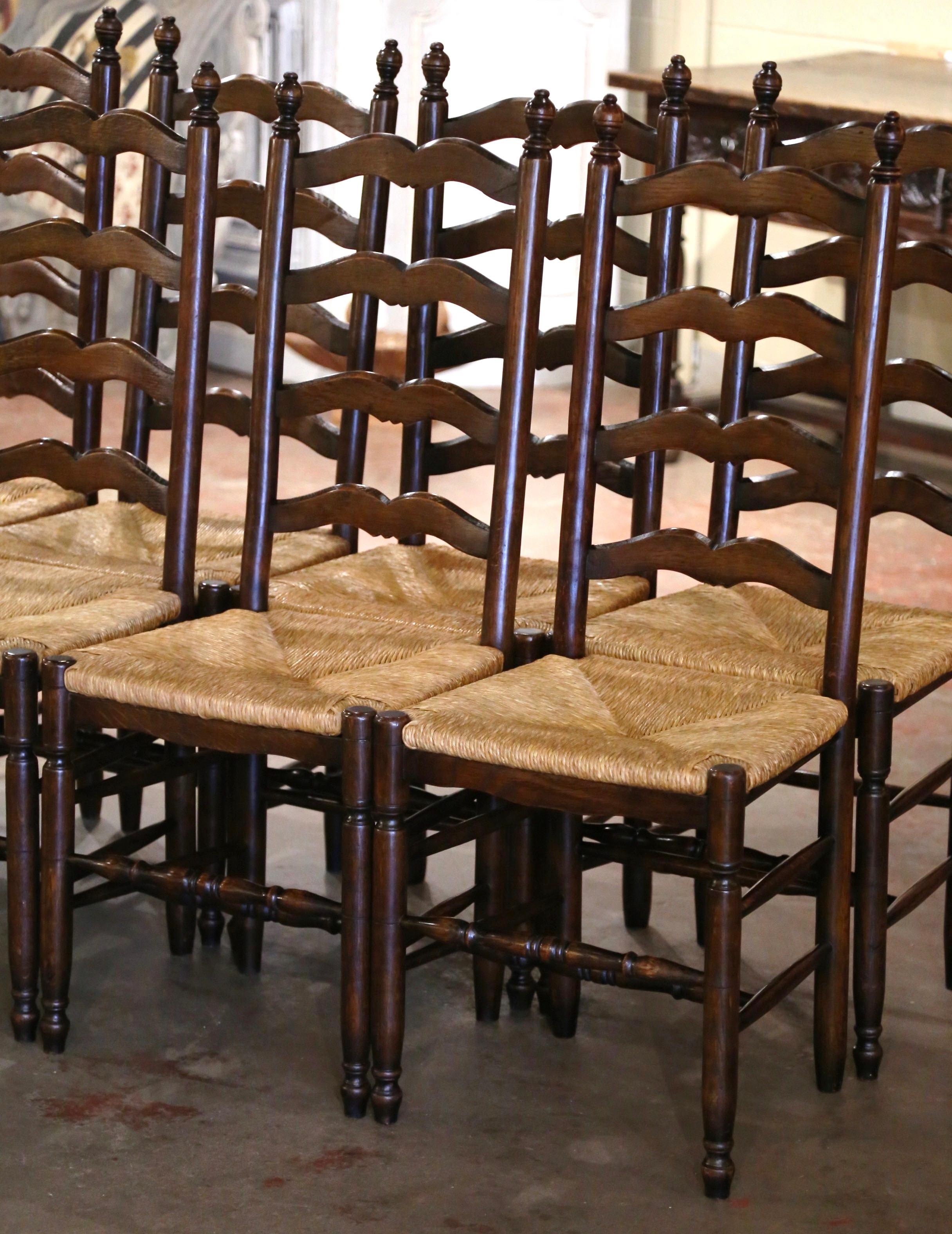 These eight elegant country chairs were crafted in Normandy France, circa 2000. Carved from walnut wood, each chair stands on turned front legs and back legs, all connected with a double bottom stretcher. Each chair has a tall pitched back with four