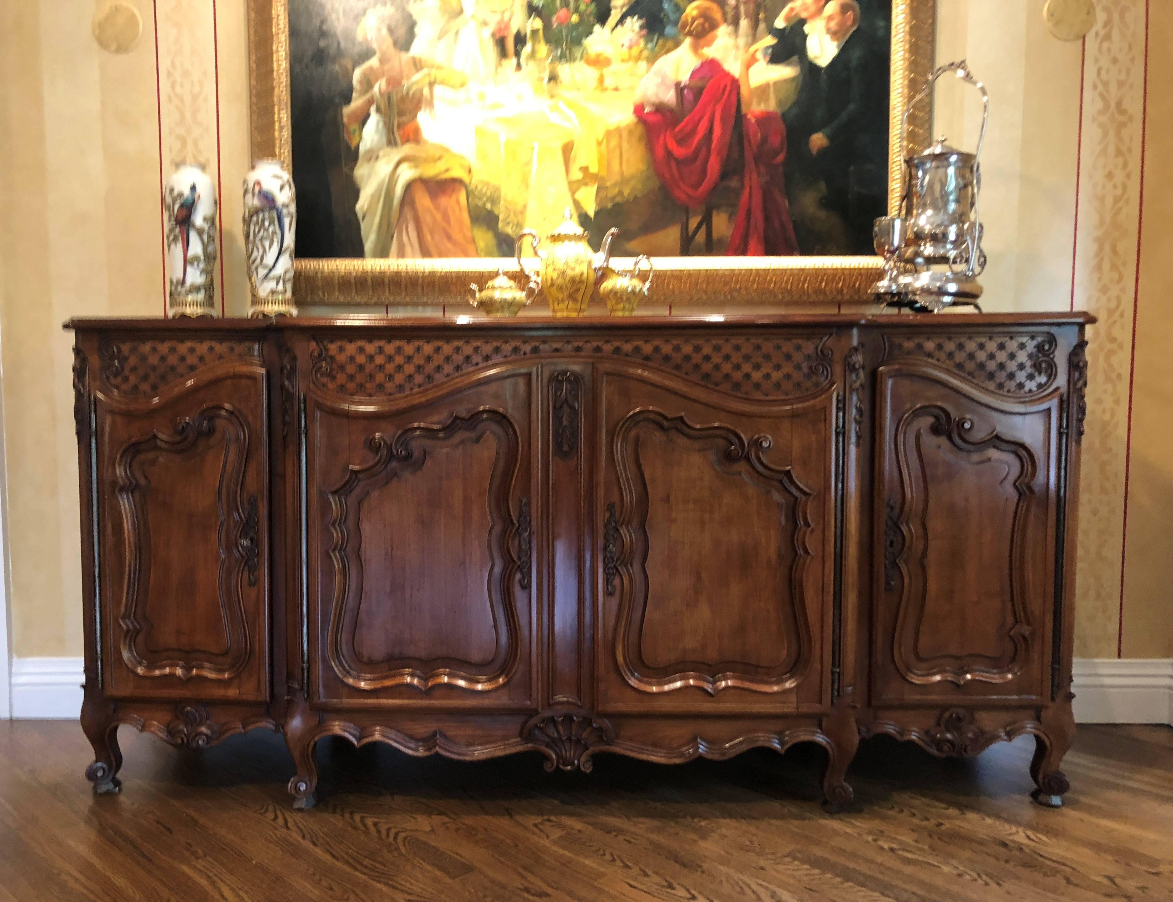 A country French cherrywood sideboard buffet in the Louis XV style. This fine custom quality sideboard or buffet has all the earmarks of an original 18th century period buffet. The attention to detail is superior. The parquetry cherrywood top