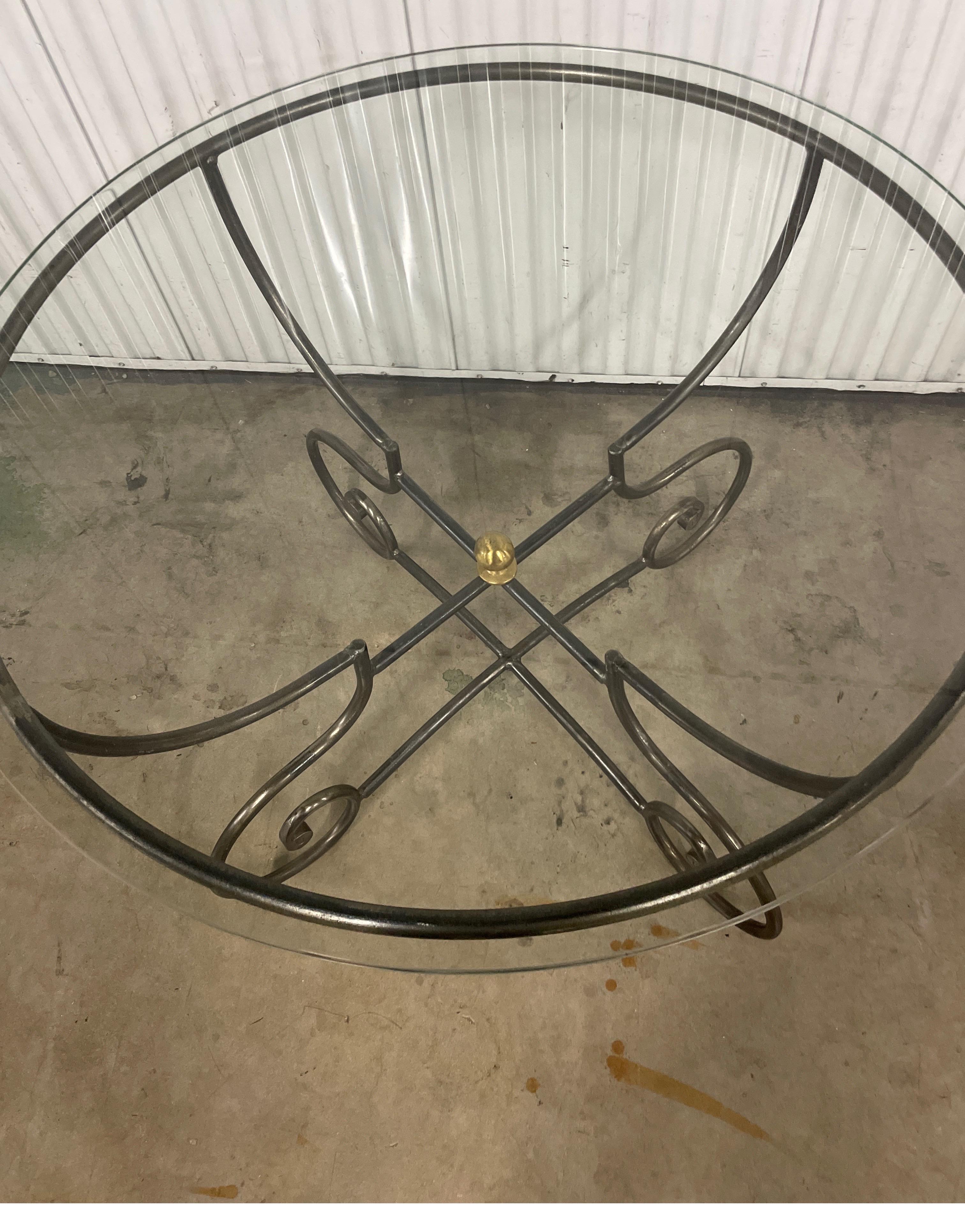Vintage Pierre Deux hand forged steel dining or center table with brass ball accent and glass top.  The diameter of glass top is 39.75
