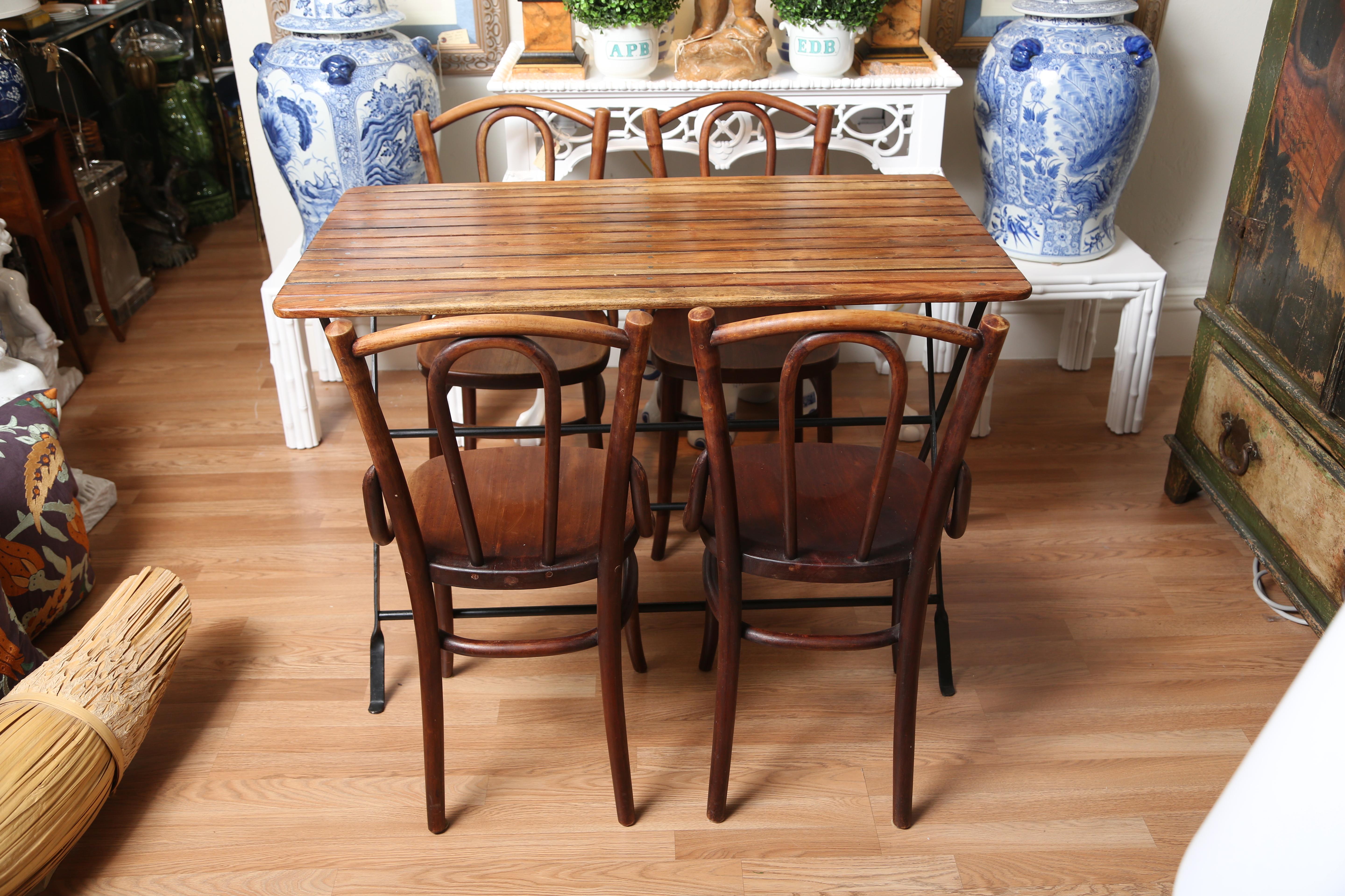 French wood slat folding Campaign table along with four companion chairs.
