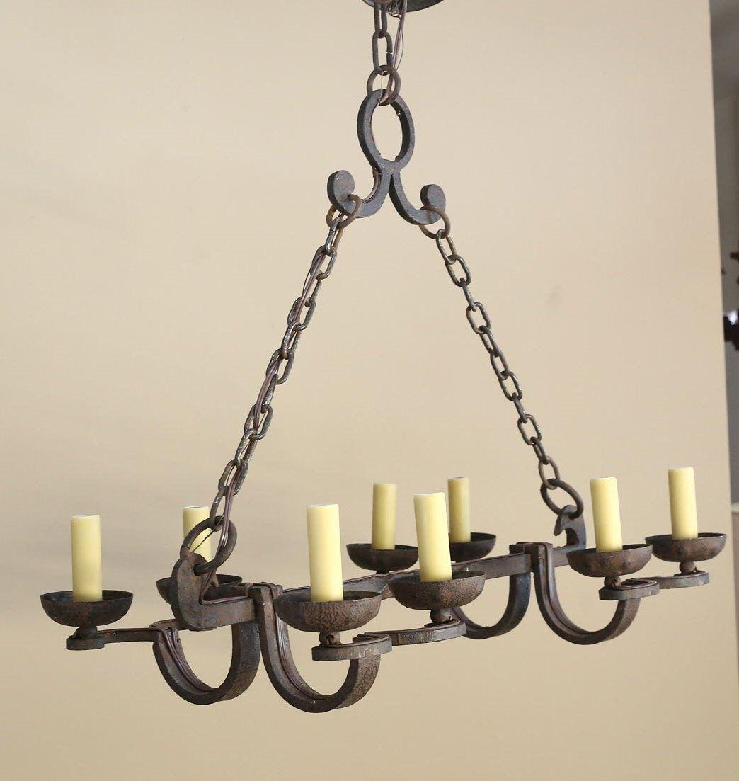 This forged iron chandelier is of nice, heavy quality and has ebbs wired in the US with candelabra sockets that can accommodate up to 60 watts each. The first two chains go up to a connector and the single chain attaches to the canopy. The light has