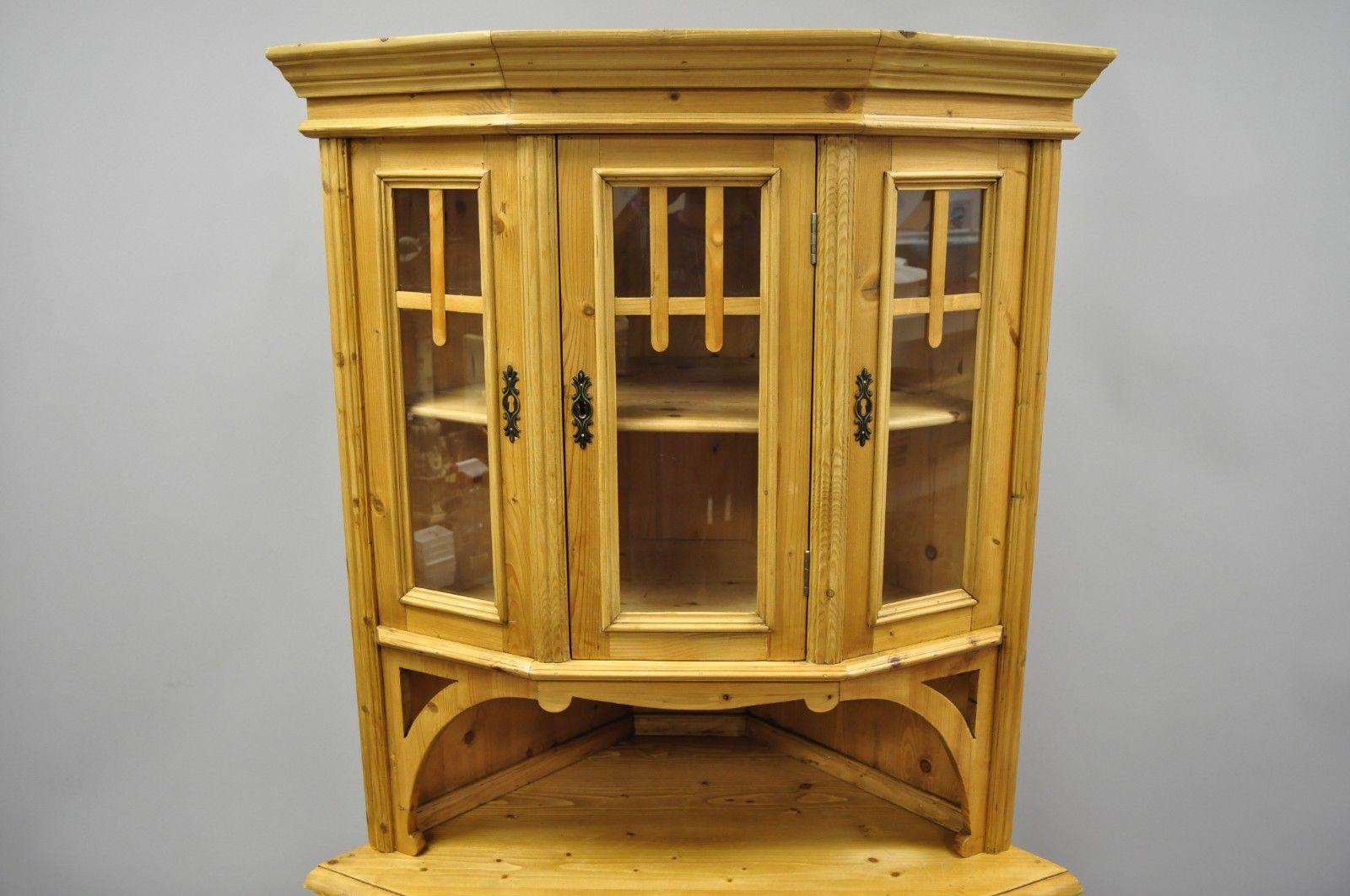 Pine wood country French primitive corner cupboard cabinet. Item features solid wood construction, beautiful wood grain, two part construction, two swing doors, working lock and key, 1 dovetailed drawer, and wooden shelves, late 20th century.