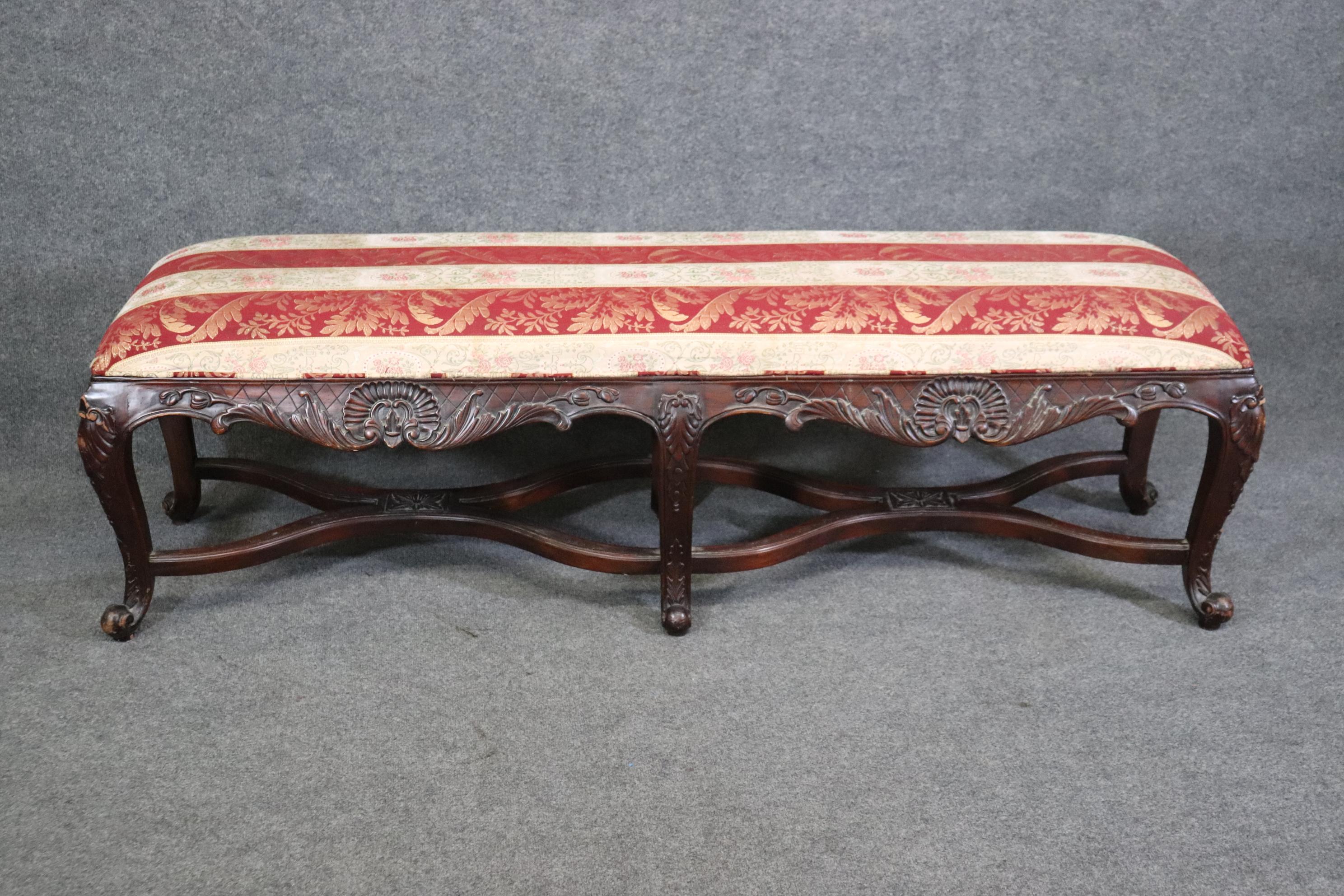 Dimensions - H: 21 1/2in W: 68 1/2in D: 18 1/2in 

This Country French Louis XV style carved window bench is made of the highest quality! If you look a the photos provided, you will see the sophisticated red and gold upholstery as well as the
