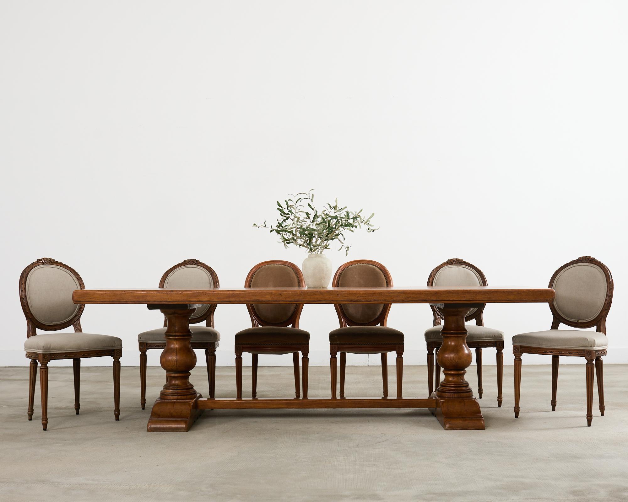 Table de salle à manger de style campagne française construite en bois de chêne massif. La table est dotée d'un grand plateau en planches mesurant plus de 8 pieds de long et 3 pouces d'épaisseur. Le plateau est soutenu par une base à tréteaux avec