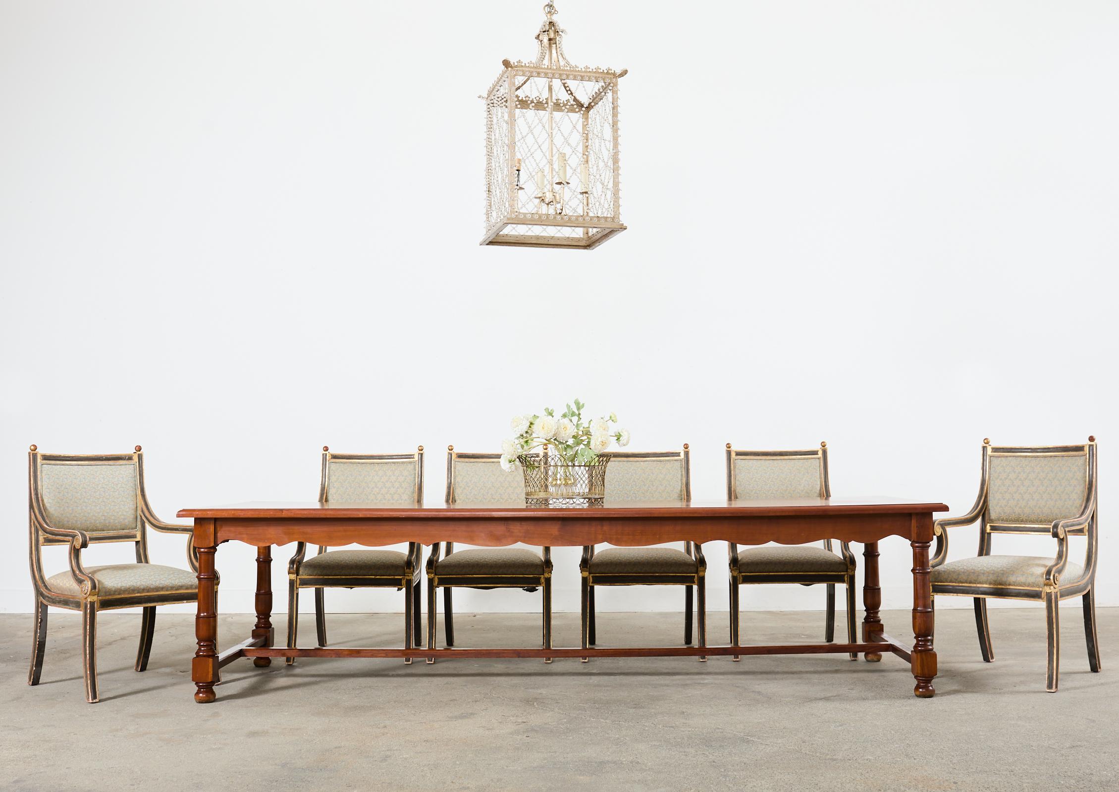 Grand country French provincial farmhouse dining table made on a monumental scale measuring nearly 10 feet long. Hand-crafted from fruitwood with peg joinery. The massive top is thick and features framed panels of book matched planks showcasing the