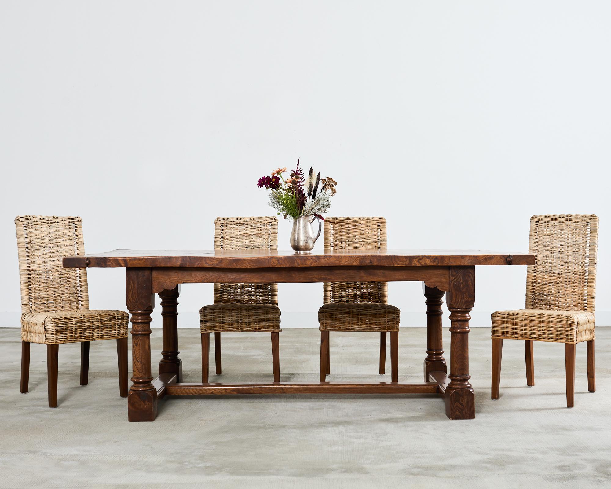 Fascinating country French provincial style farmhouse dining table featuring a rustic hardwood hand-hewn top. The 2 inch thick top is hand-crafted from planks having bread board ends and amazing knotty woodgrain patterns. The top is supported by an