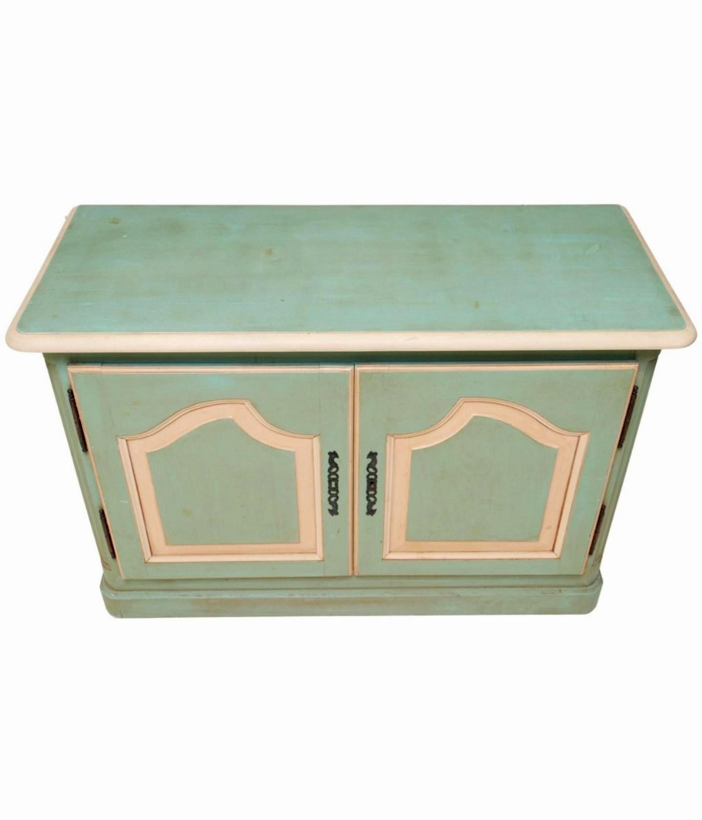 A charming vintage 18th century Louis XV style paint-decorated solid wood country French enfilade.

Born in France in the Mid-20th Century, featuring quality solid wood construction, painted soft warm light mint green and antique cream paint with