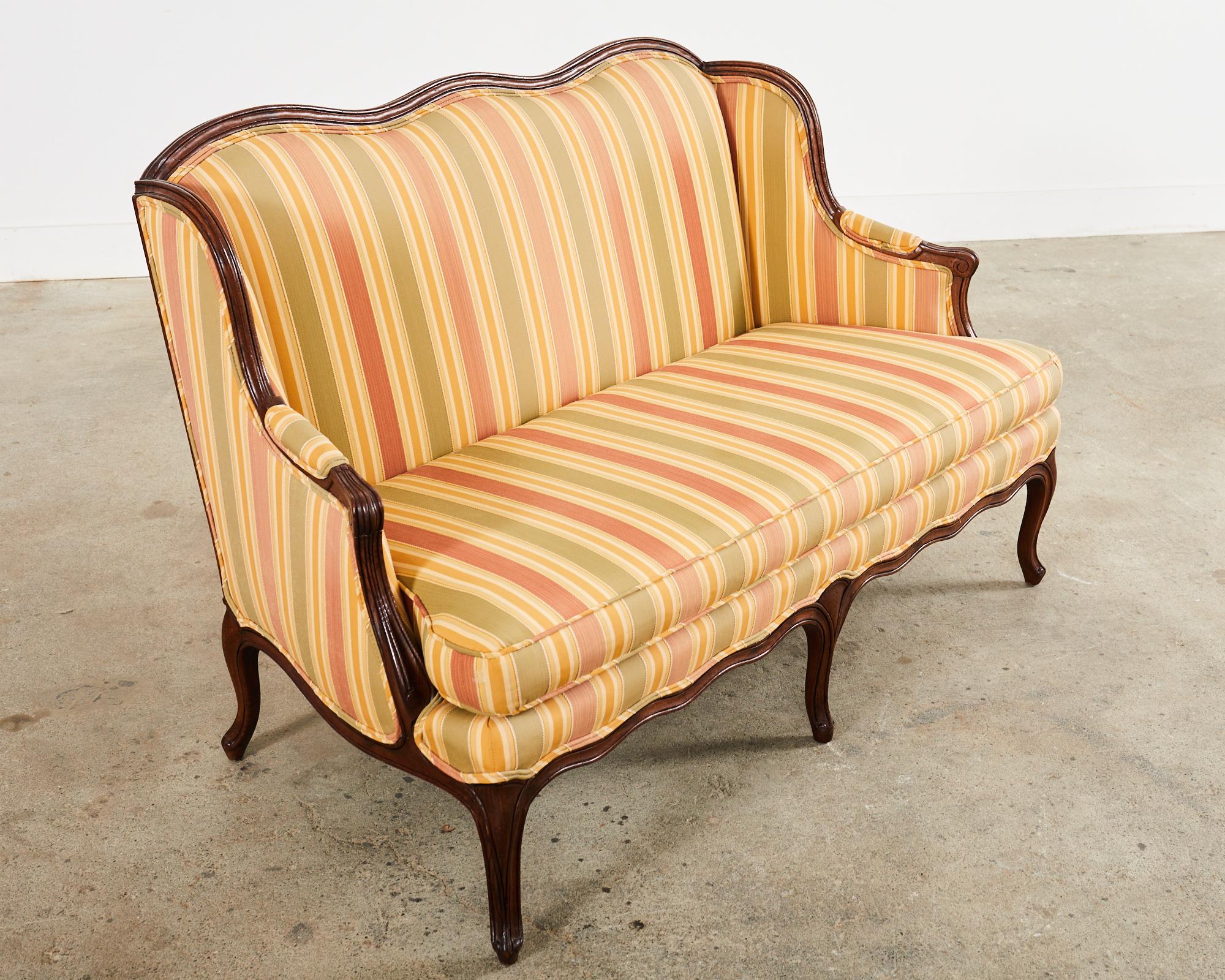 20th Century Country French Provincial Louis XV Style Serpentine Wingback Settee For Sale