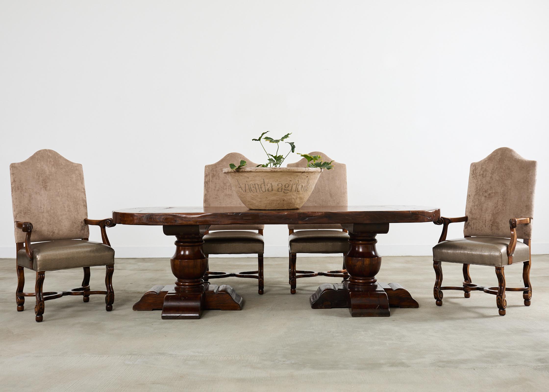 Imposing country French provincial dining table crafted from oak. The massive table features a 3.5 inch thick top board having round demilune ends. The large timbers are conjoined with numerous butterfly joints visible from the top. The boards have