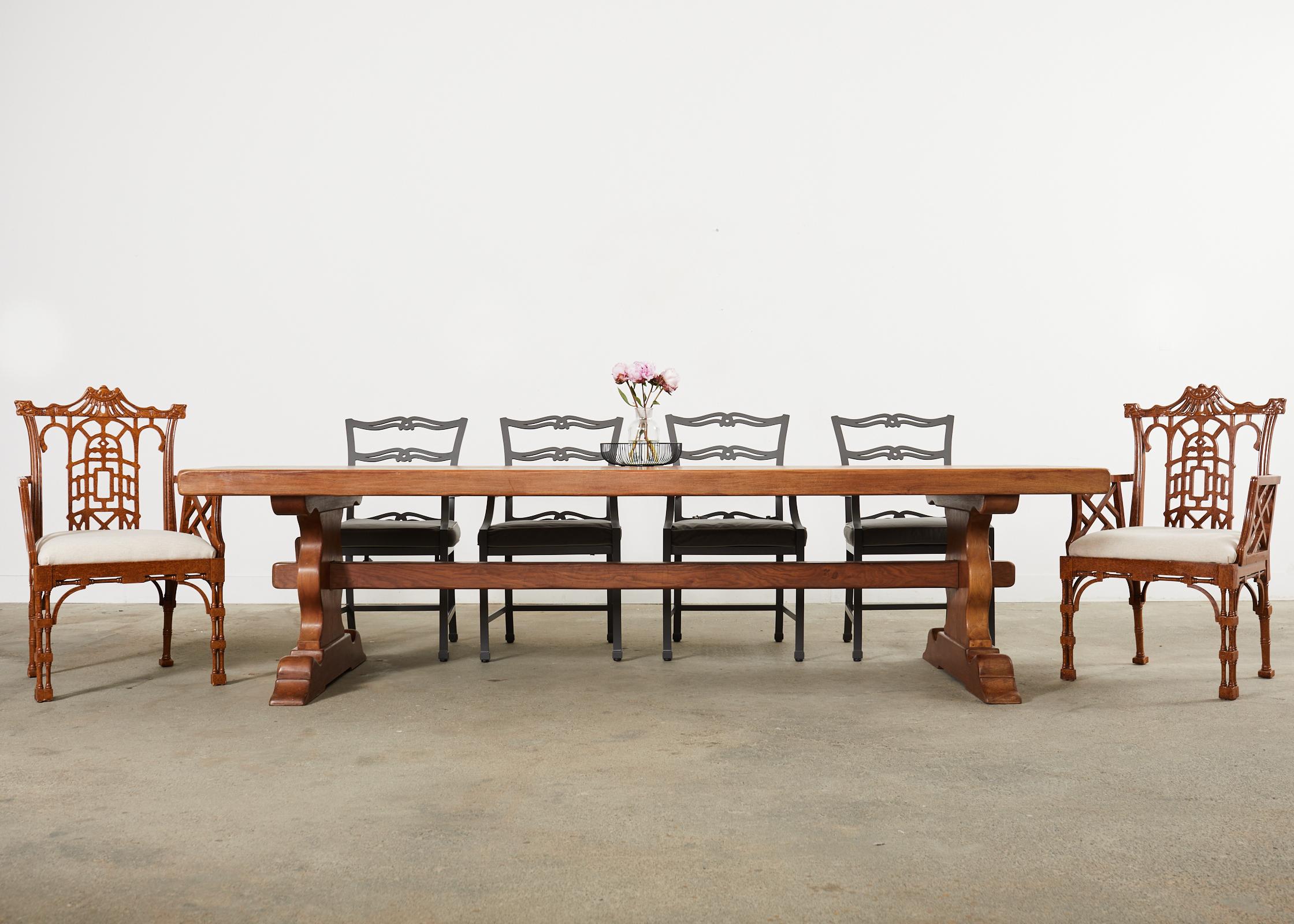 Massive country French provincial style farmhouse dining table from oak timbers. The large table features a 3.5 inch thick top of solid oak. The top is supported by a trestle base with baluster form legs conjoined by exposed mortise and tenon