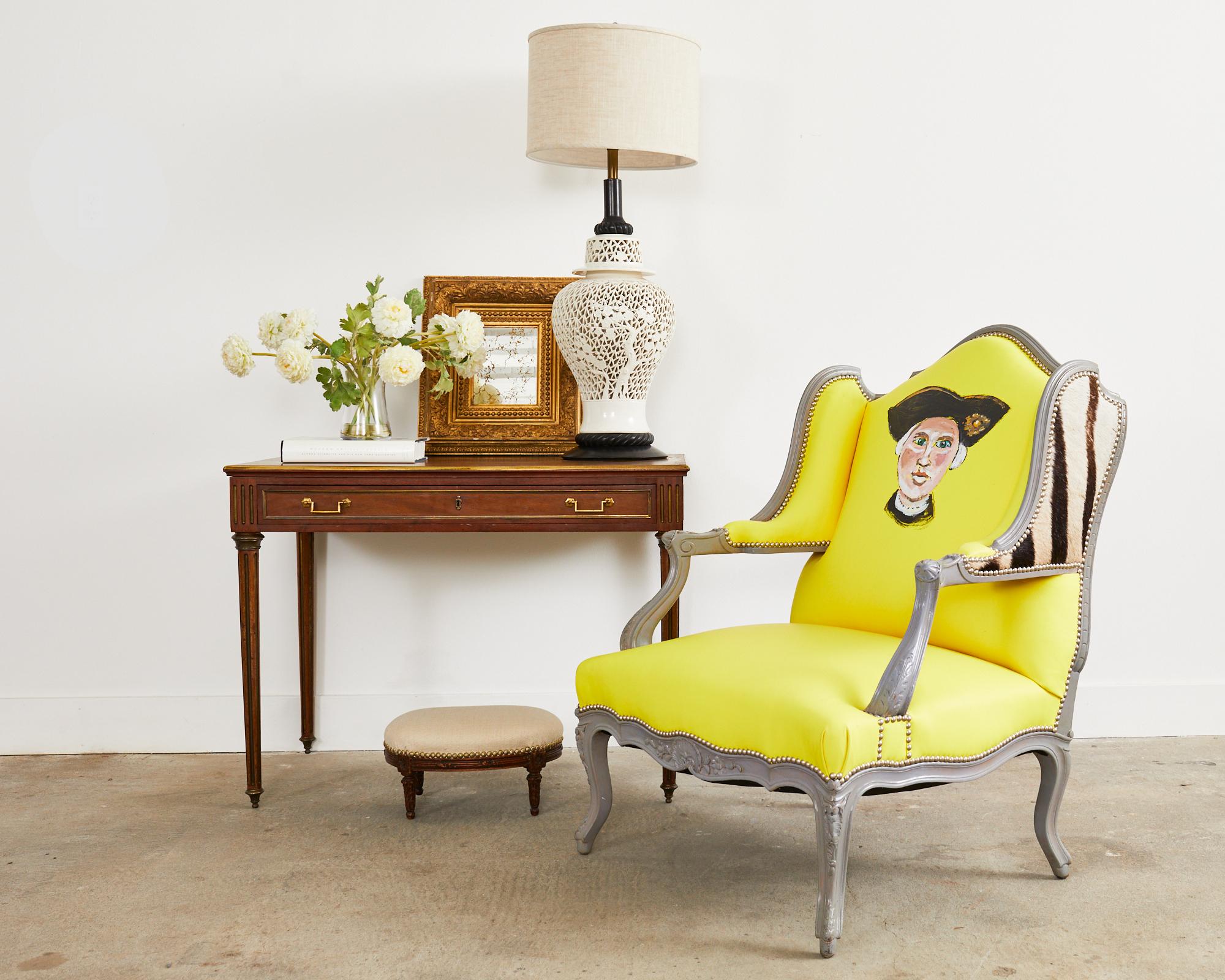 Whimsical country French provincial Fauteuil a La Reine a Oreilles or queen's wingback armchair with ears by artist Ira Yeager (American 1938-2022). The extra large size Queen's chair or chair-and-a-half is lacquered grey with an intentionally aged