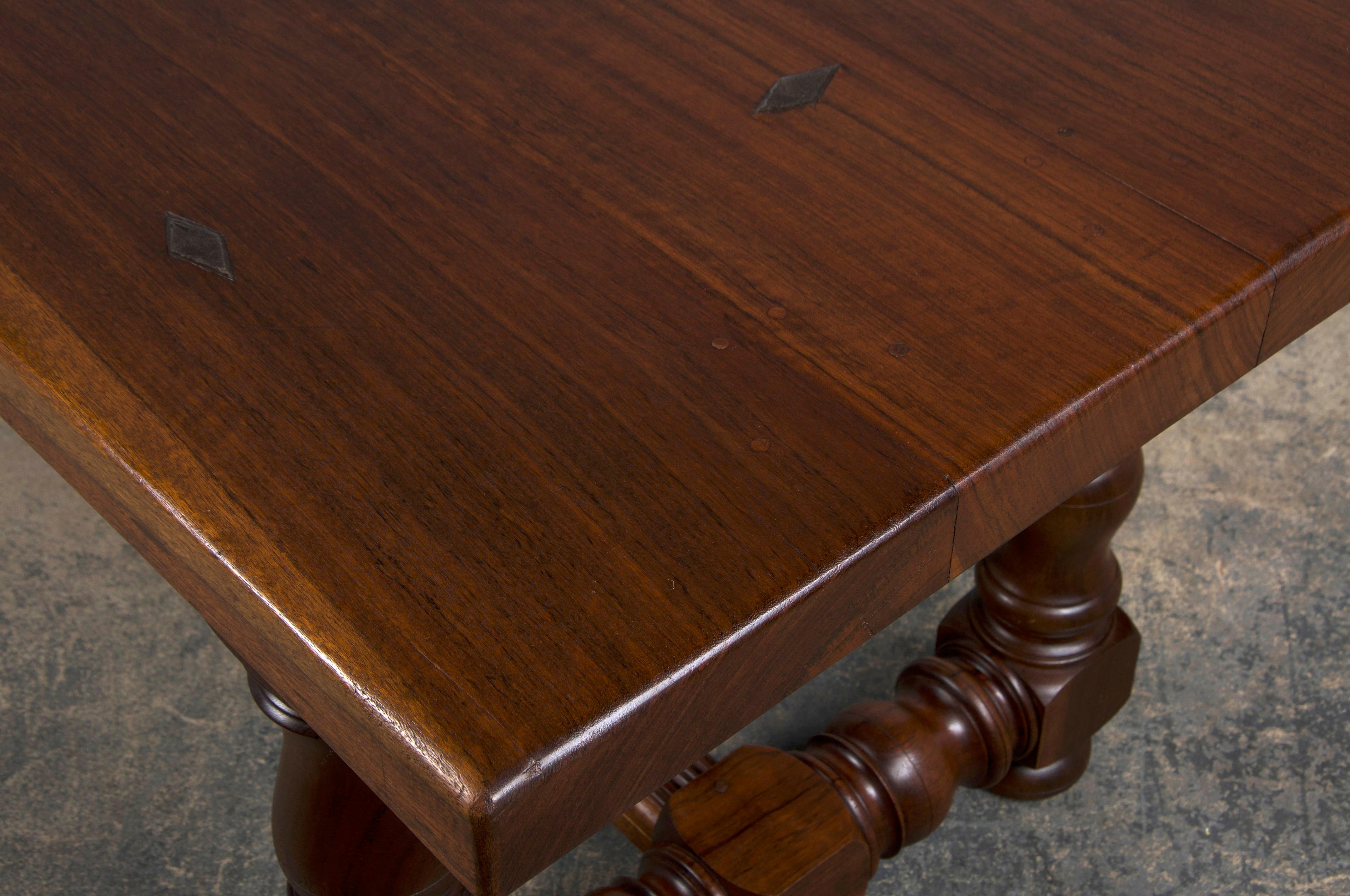 An early 20th-century French country farmhouse trestle dining table, sourced from Provence, France. Expertly handcrafted from solid walnut, it features a 7'1