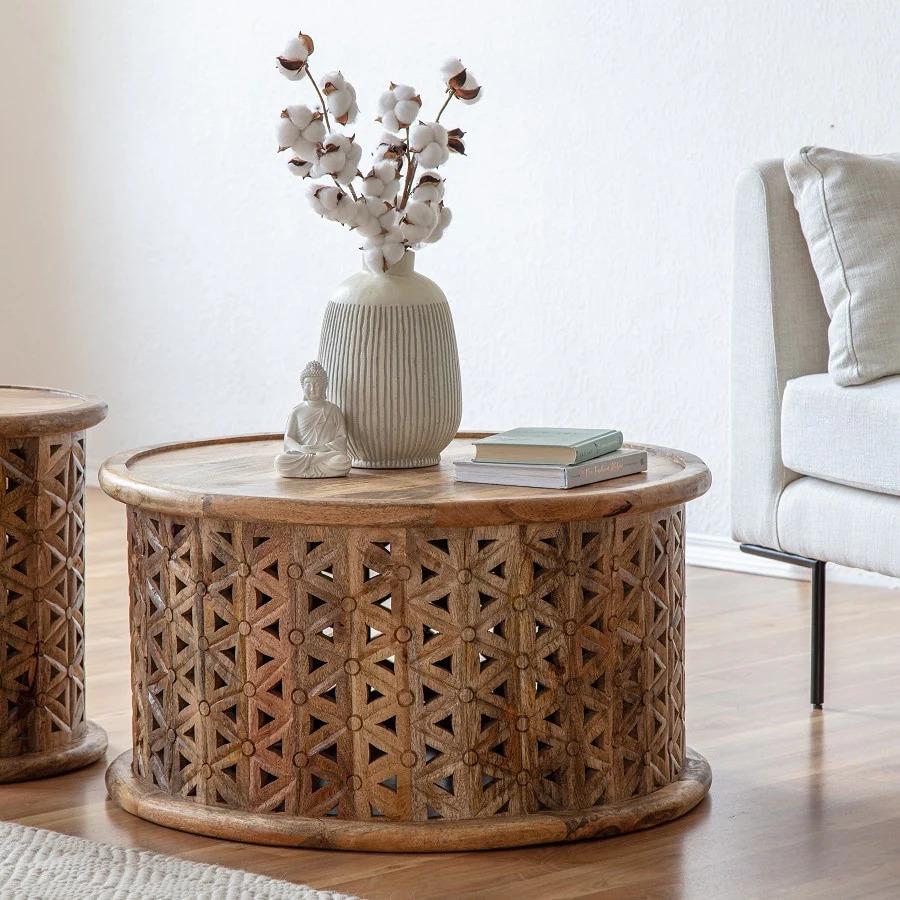 Boring is definitely out with this round mango wood rustic coffee table!  With its intricately carved warm natural panels, it will add a classy but subtle pop of interest in any light toned room.  Let it gracefully add sophistication to your lounge