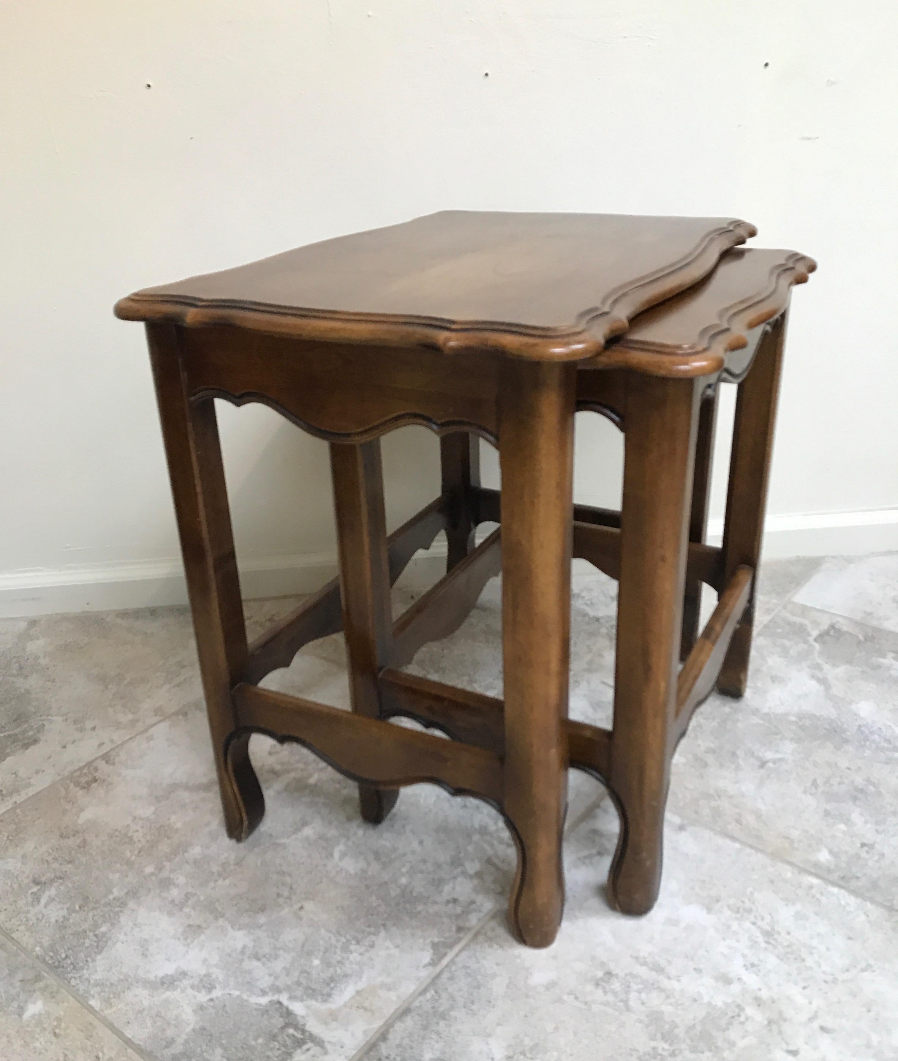 Set of two country French walnut nesting tables.