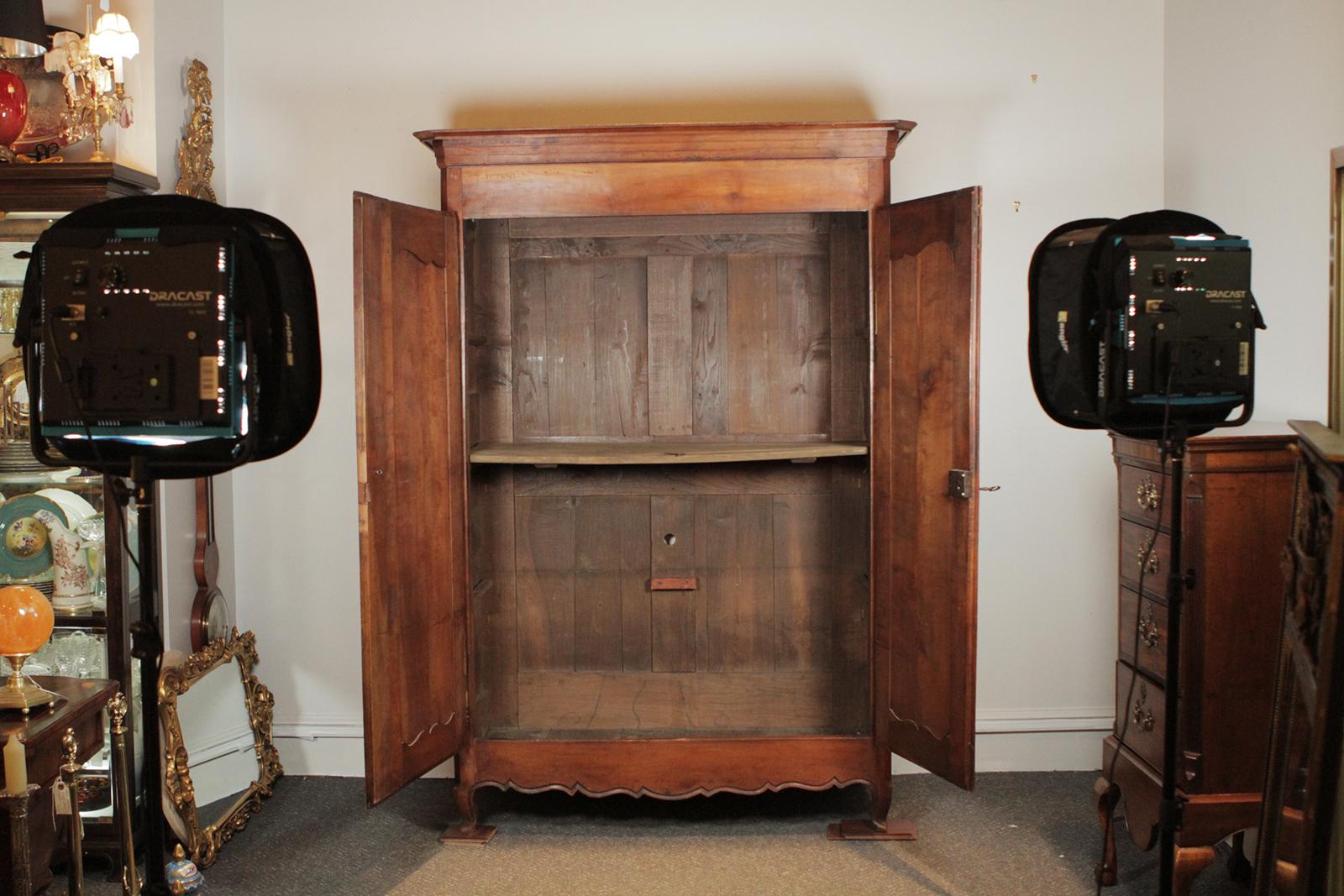 Country French two-door armoire, all hand pegged construction, circa 1800-1820.  The warm patintation of the wood is only something that can happen with age and the finish is made satiny with time.  The top cornice at its widest point is 58 inches. 