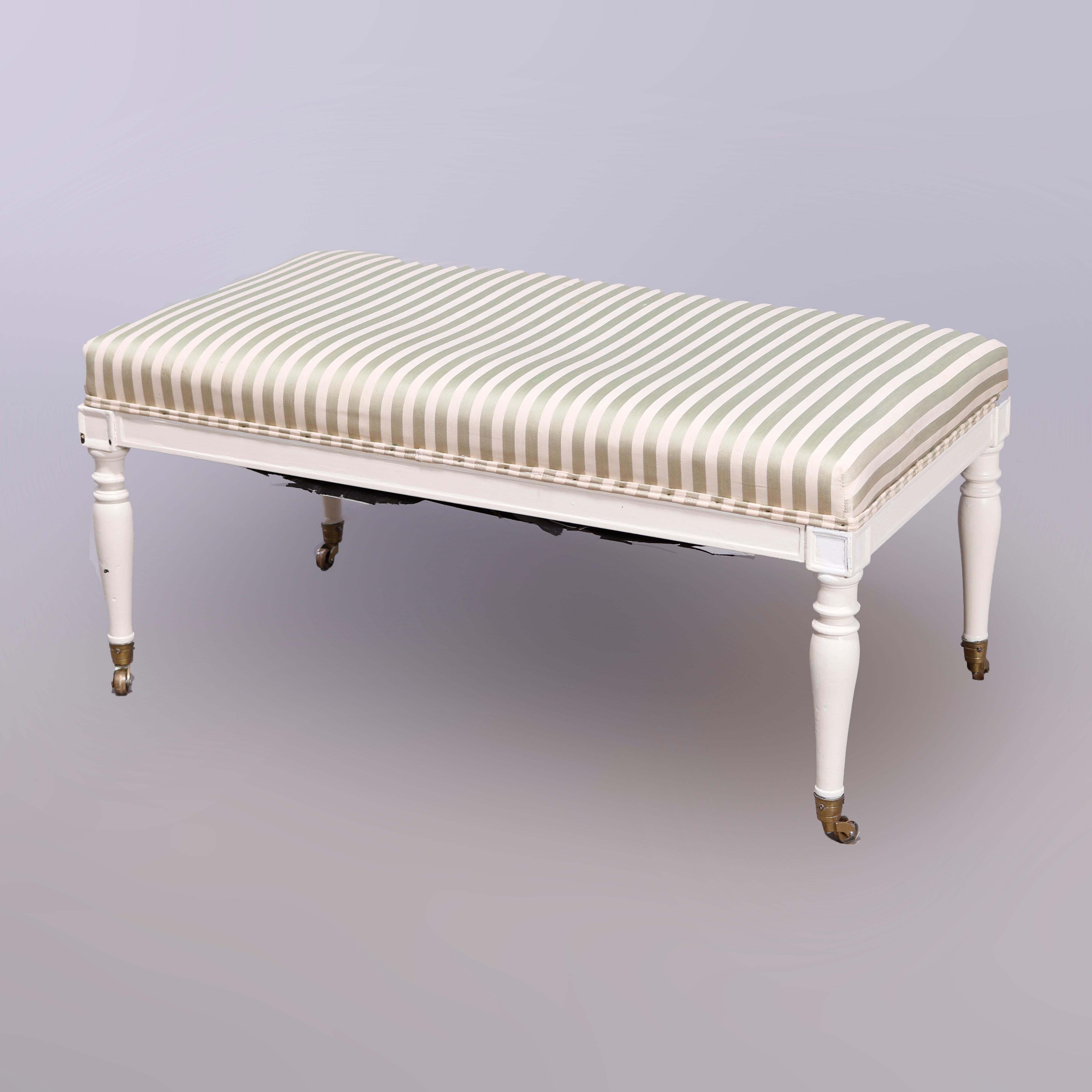 A Country French style window bench offers striped upholstered seat raised on white painted base having turned legs and casters, 20th century

Measures - 16.75'' H x 37'' W x 19.5'' D.

Catalogue Note: Ask about DISCOUNTED DELIVERY RATES available