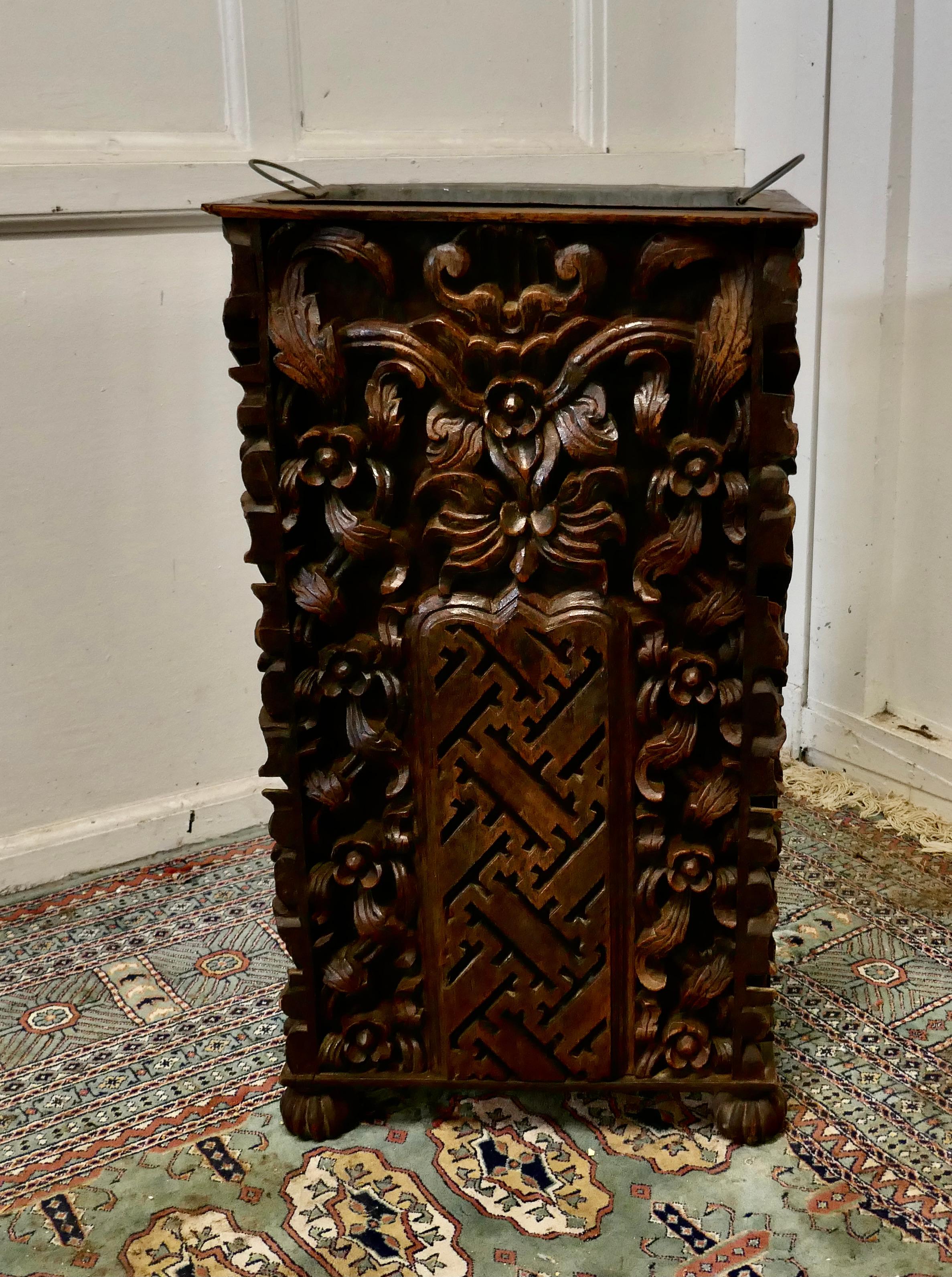 Country House carved Gothic oak umbrella stand 

A wonderfully carved piece, the stand is made in Oak it has 4 sides, all of which are deeply carved with mythical beasts and fruits of the forrest

Inside this very large piece there is a