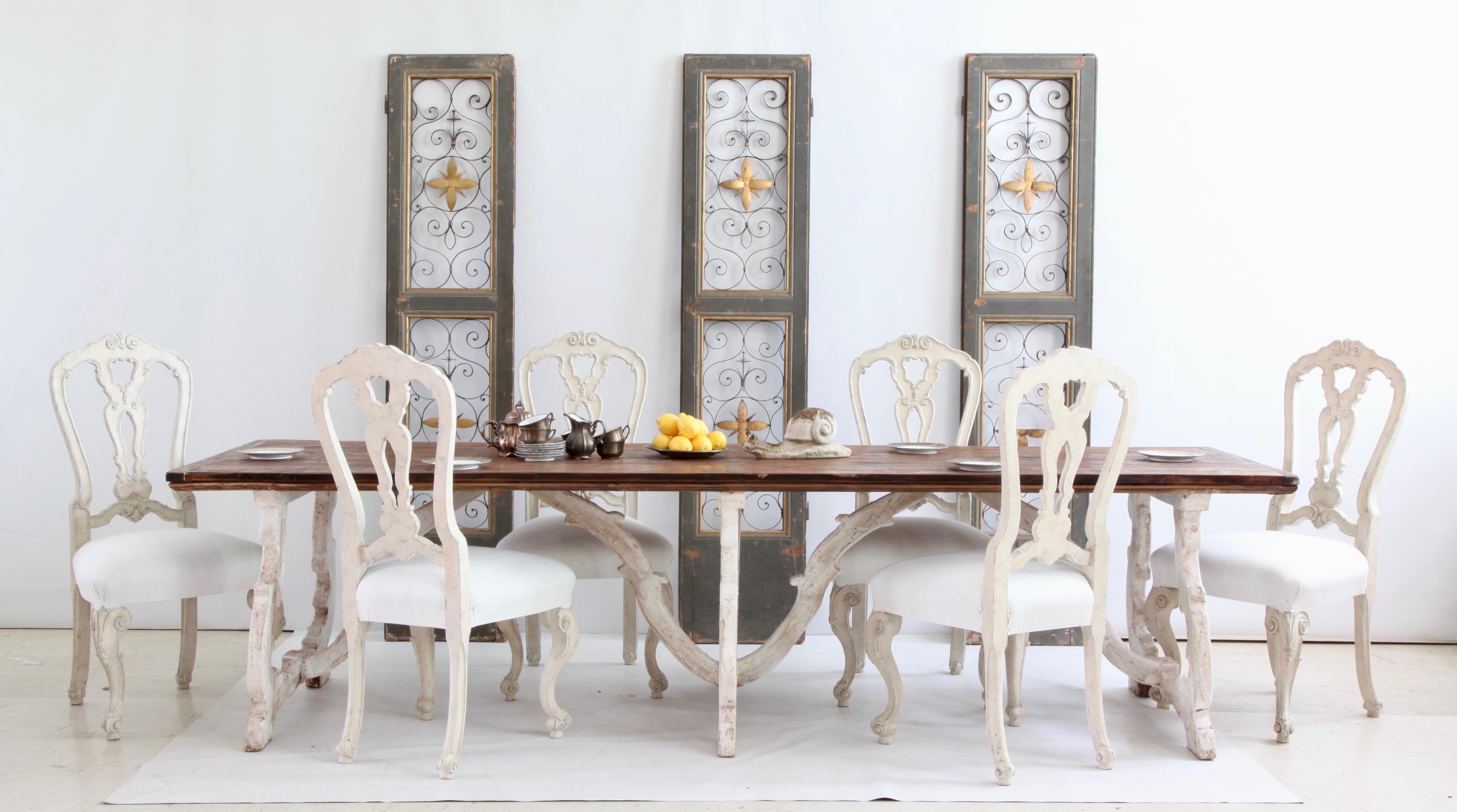 A beautifully hand crafted rustic farm house table from Tuscany, Italy finished in a two tone patina of gesso white with a contrasting natural wood finish for the top. This particular piece is rare because the joints between the legs of the table