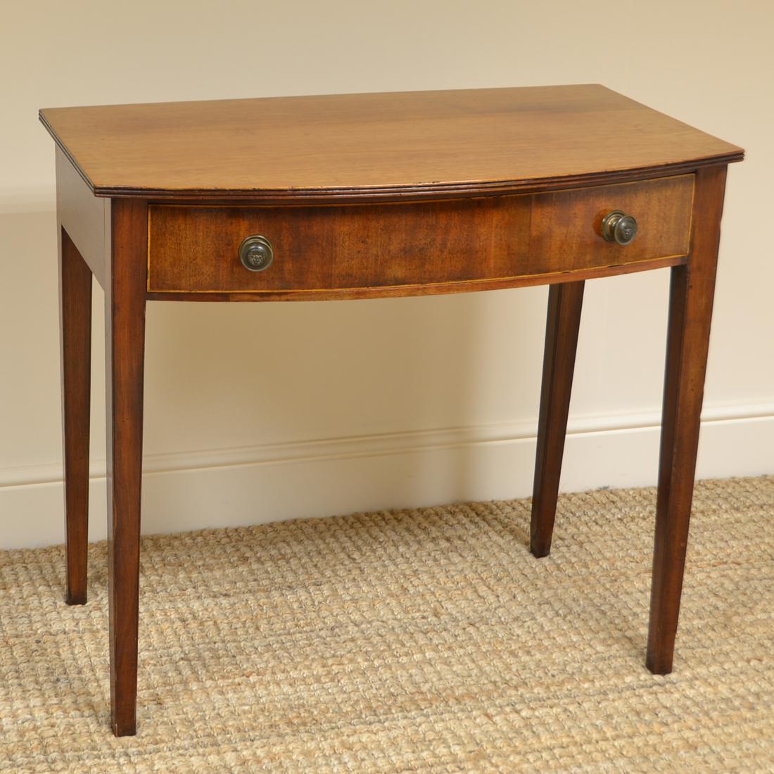 Country House Regency bow fronted antique side table
This fine Country House Regency mahogany bow fronted antique side table dates from circa 1830 and is full of beautiful charm and character. It has a beautifully figured top above a frieze drawer