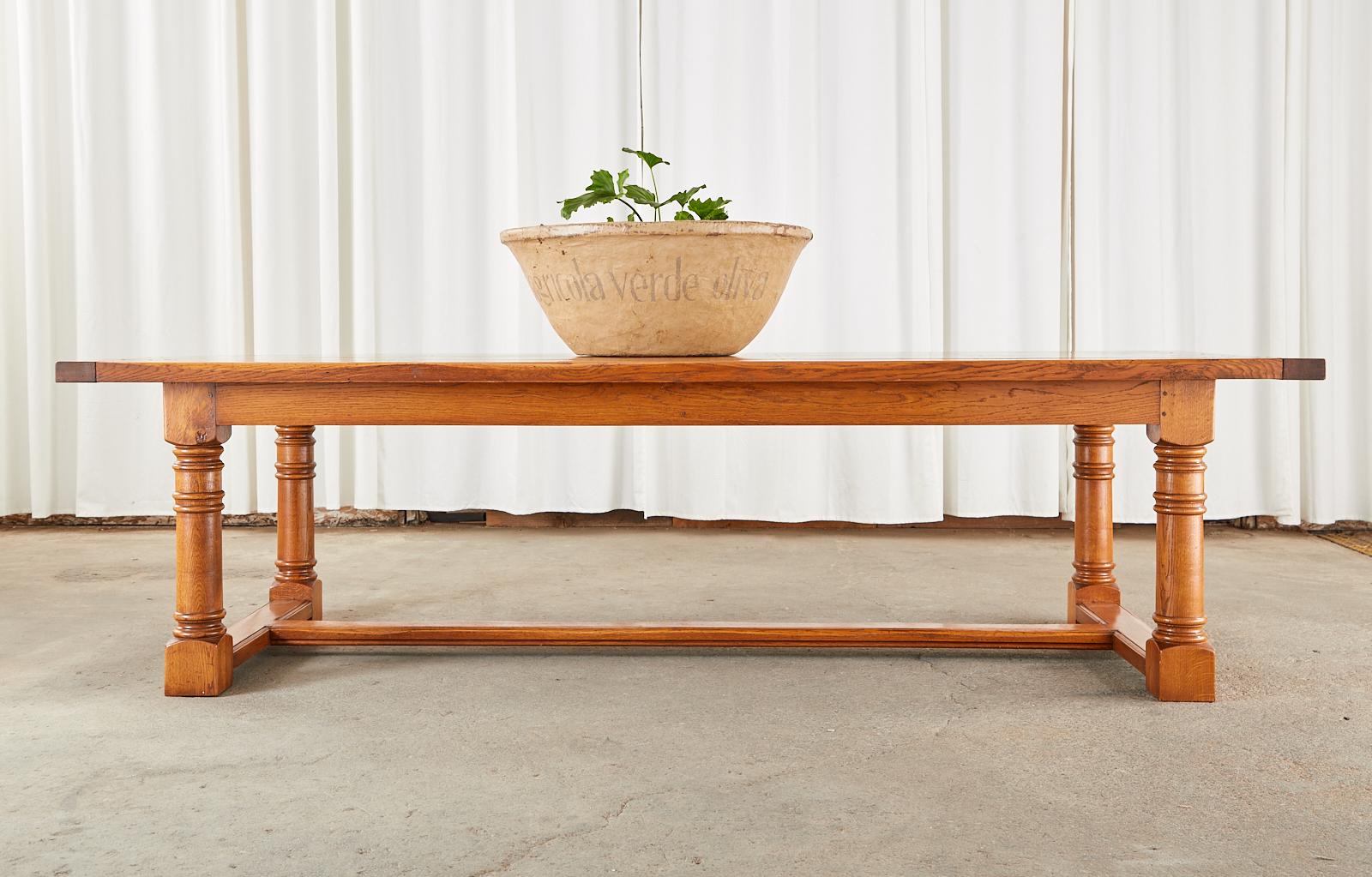 Grand scale country Italian farmhouse refectory table or dining table crafted from radiant oak. The massive rectangular top is constructed from seven oak planks measuring 2 inches thick having breadboard ends. The table is made with wood peg