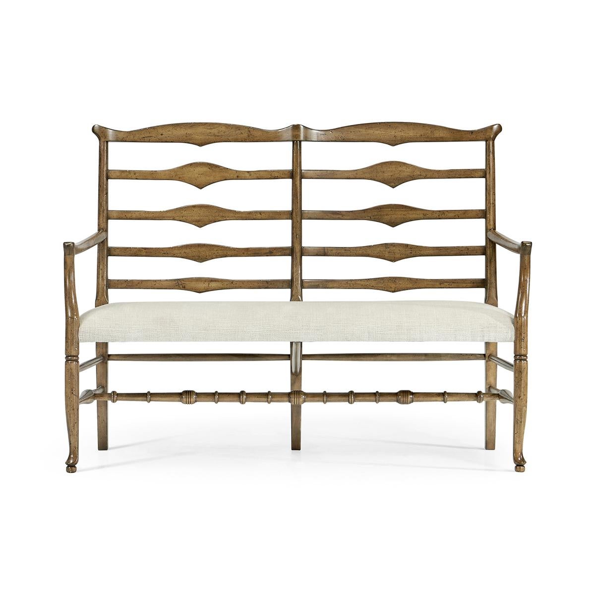 Country Ladder Back Bench, this English country-style medium driftwood ladder back two-seat bench has a shaped back rail, graduated ladder slats with triangular shaping in the center and an upholstered seat. Turned legs and stretchers
