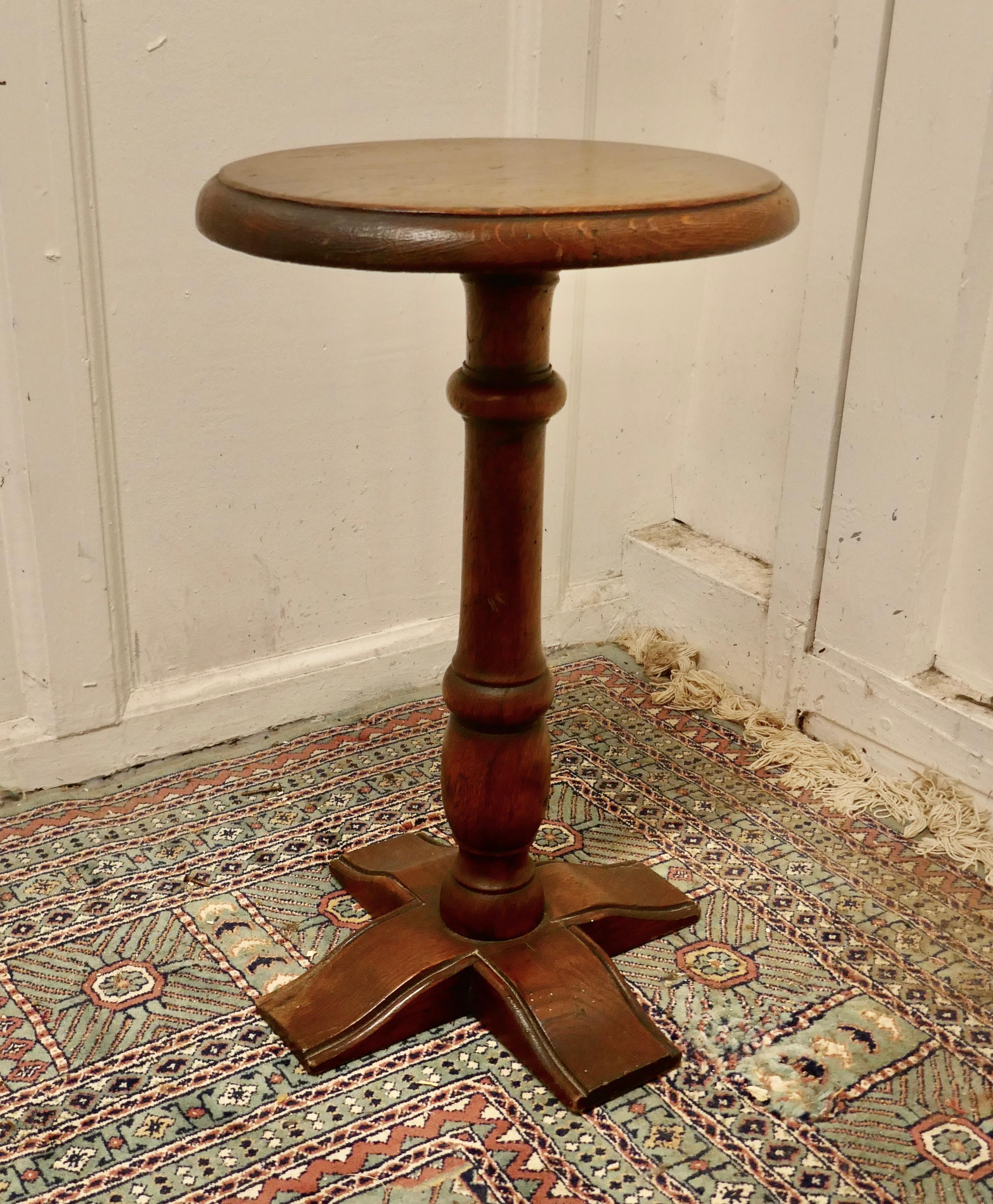 Country oak wine table or occasional table

This lovely little table stands on an attractive X footed base and has a attractive turned leg 
The 1” thick solid top is unusually an oval shape
The table is in good condition for its age
The table