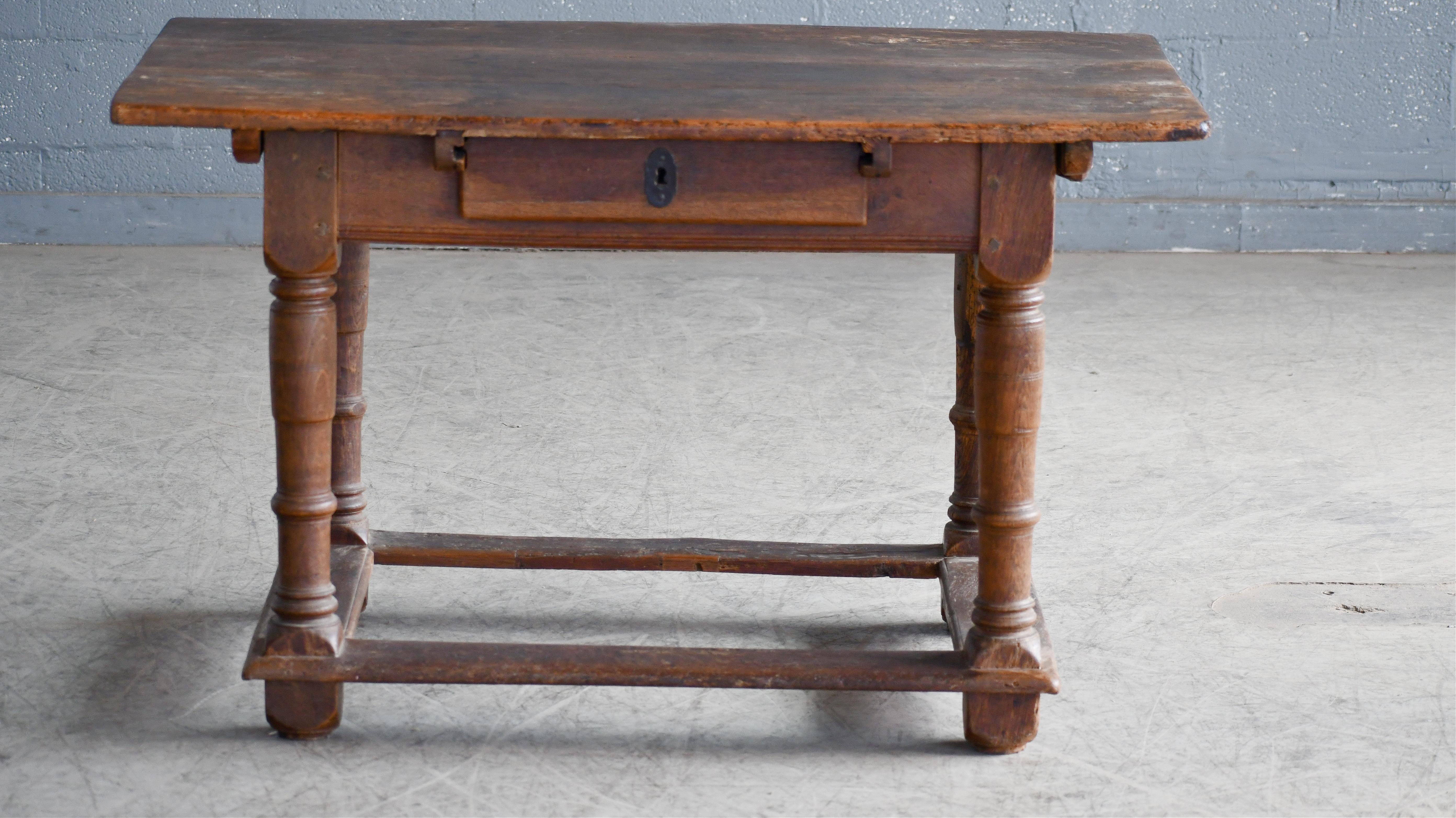 We found this charming country console table table in Denmark - entirely made of thick solid oak. Probably made around 1900 and remains sturdy and strong. The tabletop shows some sign of wear and age and probably had some kind of work purpose based