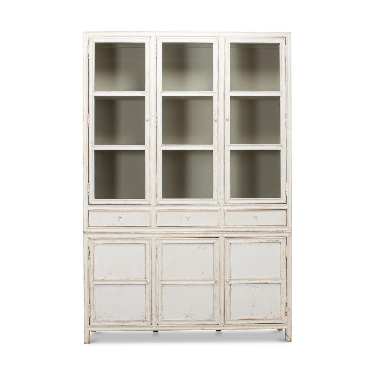 The Country painted display cabinet is made with reclaimed pine and has a hand-rubbed white painted antiqued distressed finish. The upper section with three glass doors above three drawers sitting atop three enclosed cabinets below.

Dimensions: