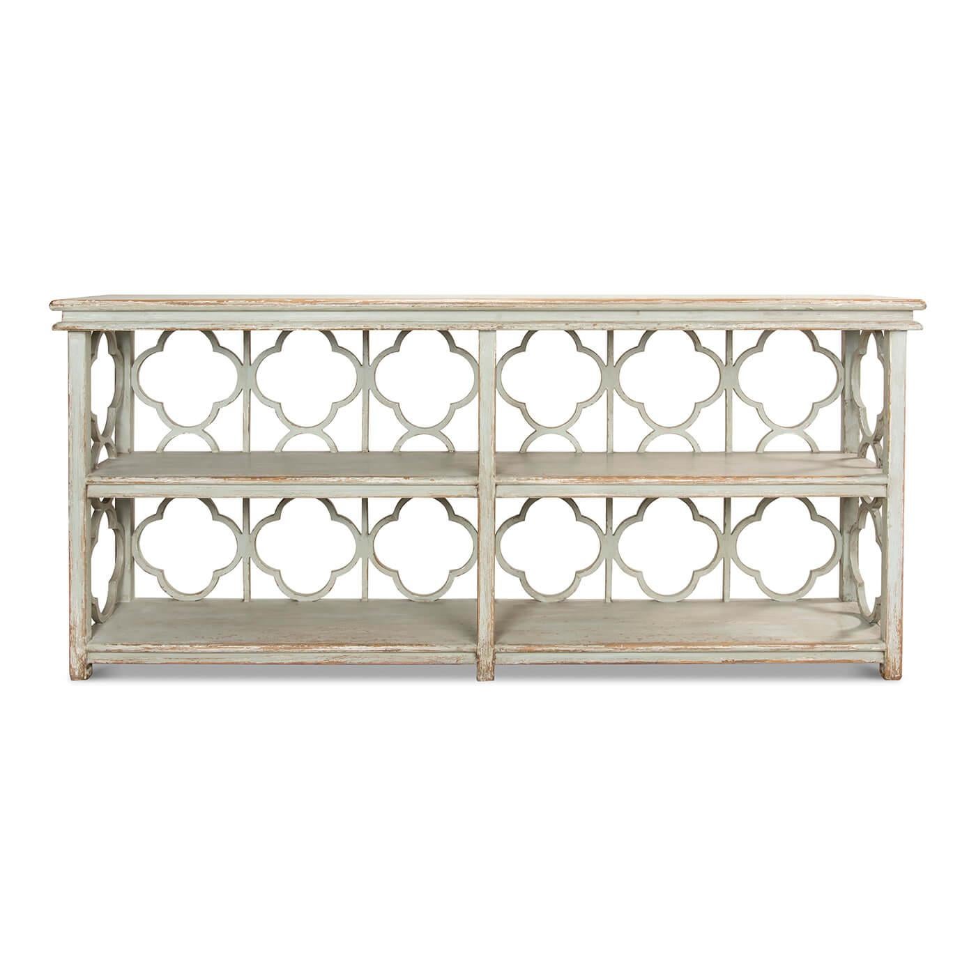 French Country Painted Quatrefoil bookcase or long console table with a painted green distressed finish. A beautiful piece for book storage and display, this bookcase console table features an openwork quatrefoil design on the back and sides.