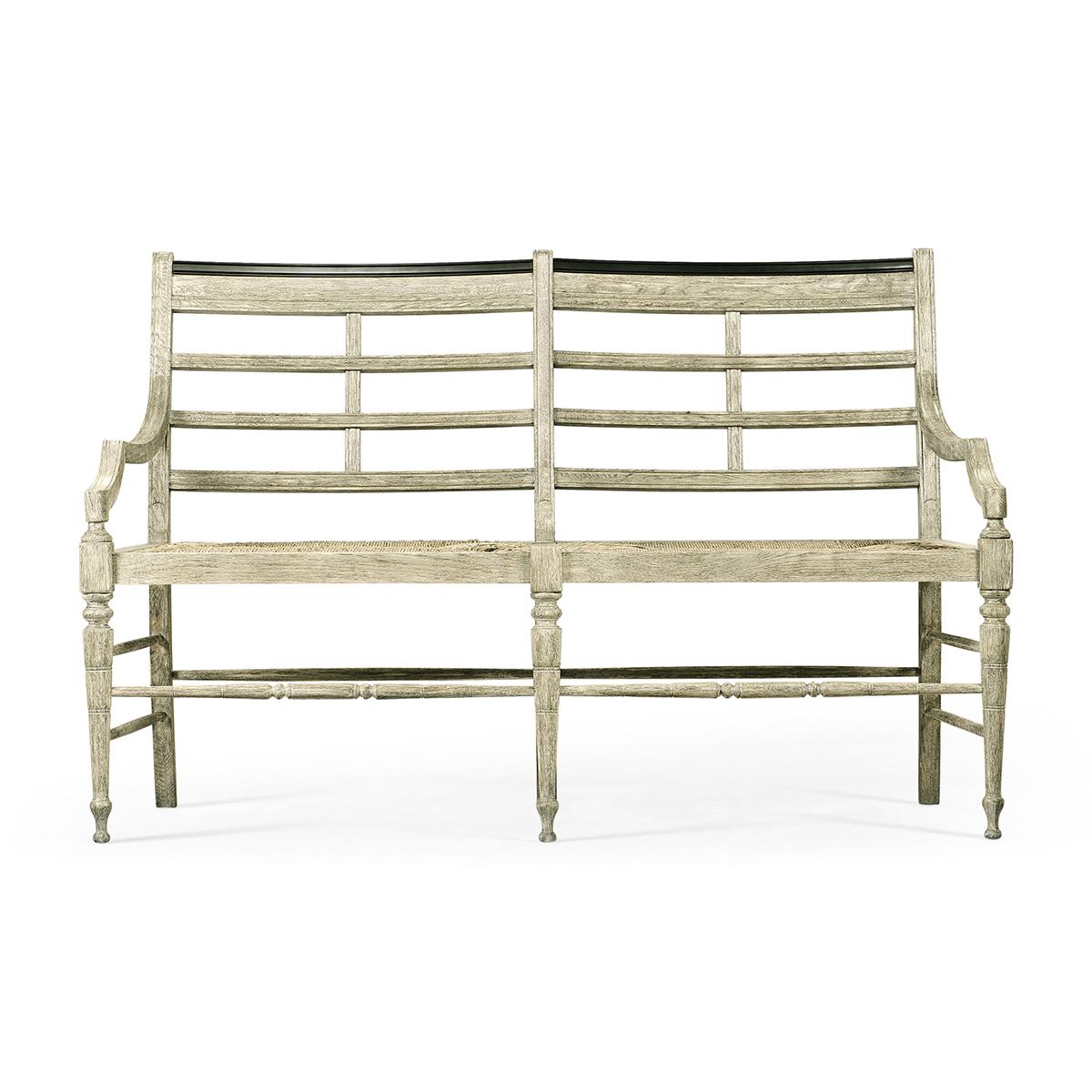 Country Painted Settee, a gray painted oak finish in a rustic country style, with molded slat backs, on rush seats, with turned and tapered legs and a stretcher base.

Dimensions: 59