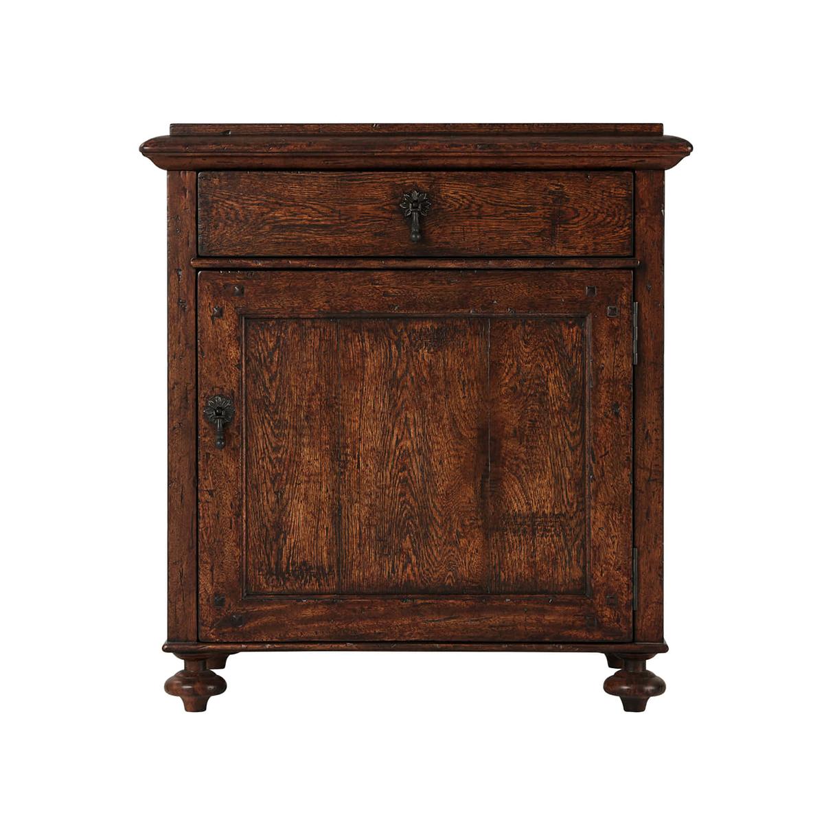 A Country rustic oak bedside table featuring a molded oak top above a frieze drawer and cabinet door with bronze-finished pendant handles and finely turned feet.

Dimensions: 26