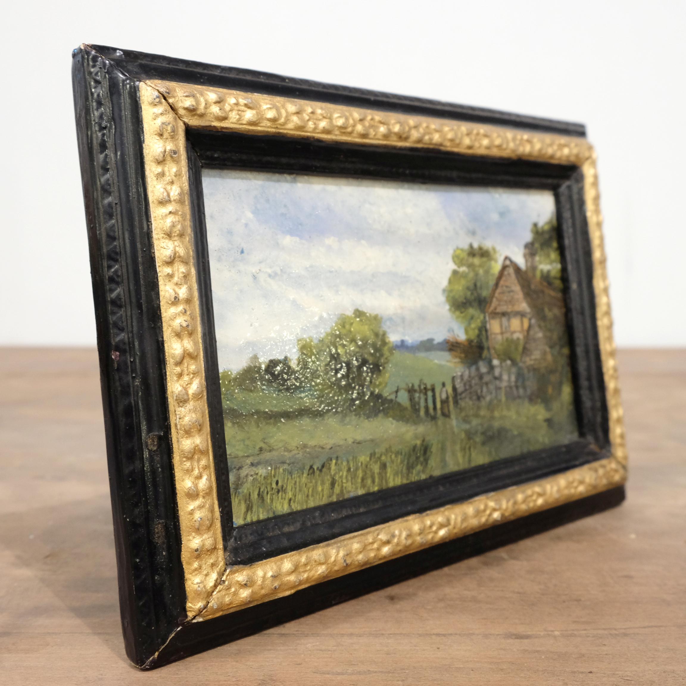 Charming little oil on panel of an evocative farmstead in a country landscape. In period gilt and ebonized style frame (currently arranged as a table standing frame but has rings to be wall hung - stand removable). Possible indistinct signature,
