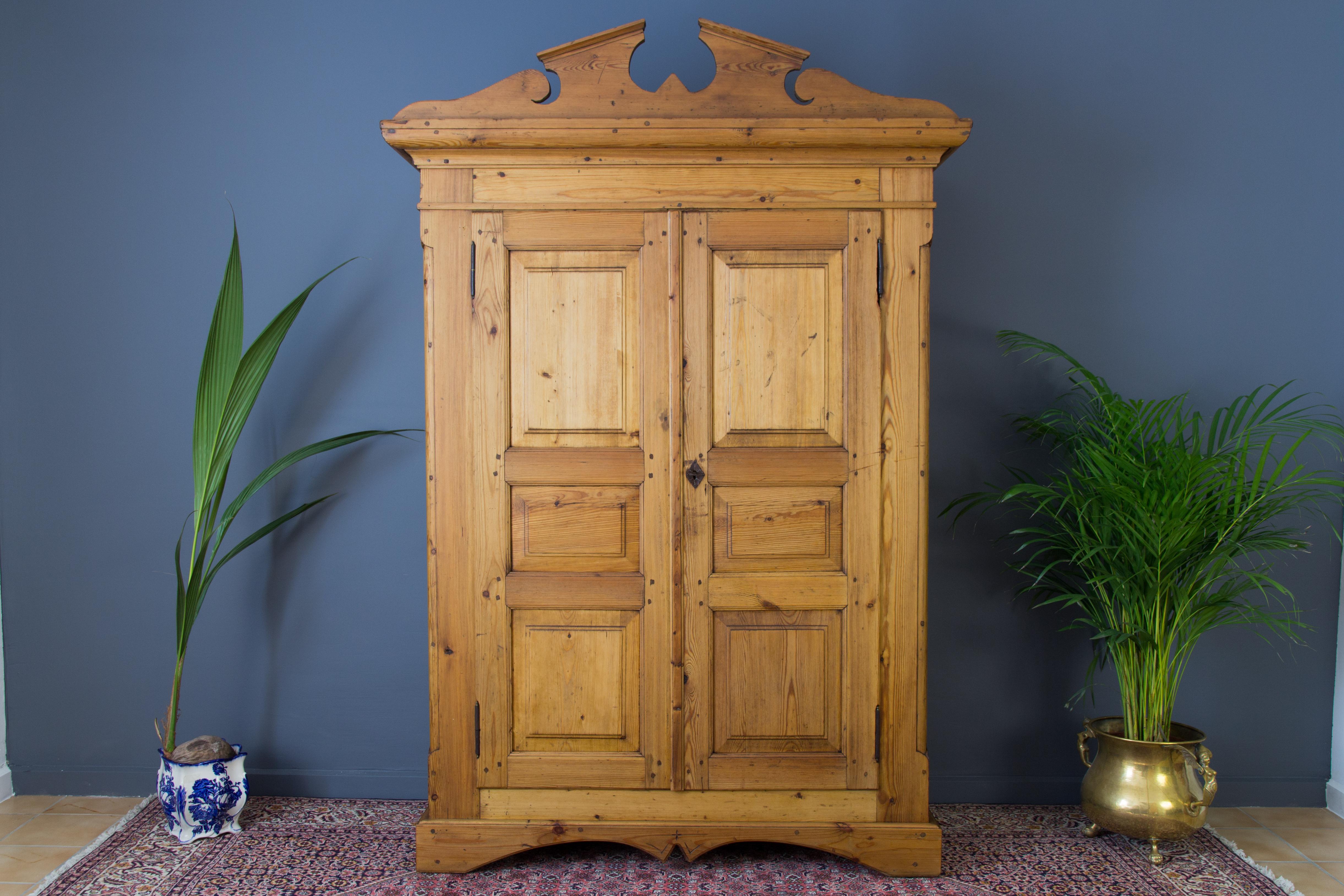 Beautiful early 20th century two-door armoire of Baltic Pine. This antique wardrobe has three shelves in each side. The wardrobe is in one piece and is of very solid construction and in very good antique condition. Please expect some dents, marks