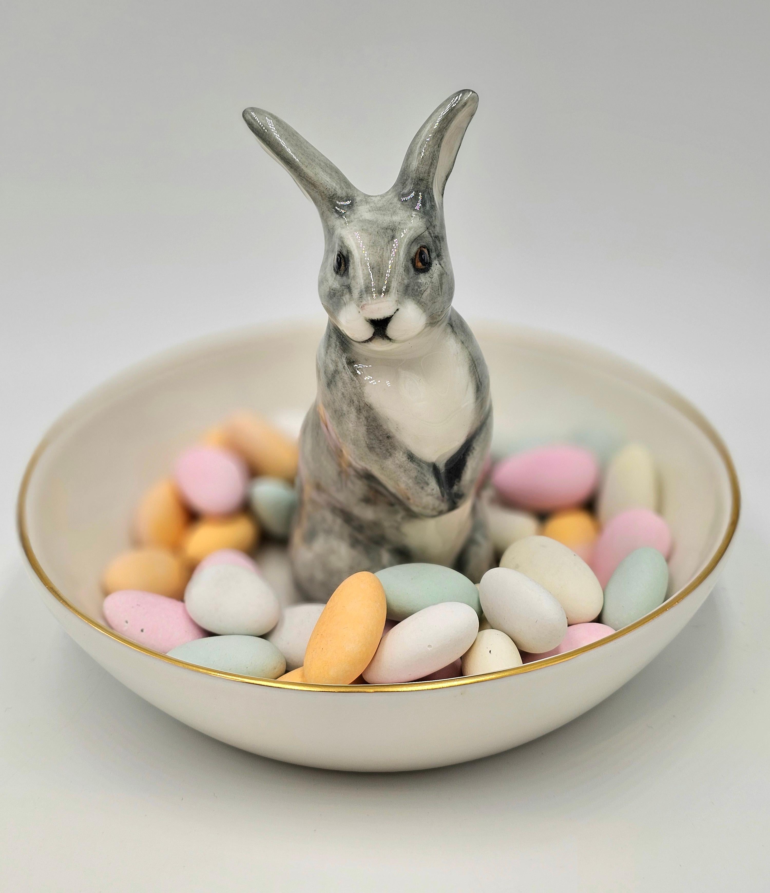 Completely handmade porcelain bowl with a hands-free naturalistic painted hare figure with grey spots. The Easter bunny is sitting in the middle of the bowl for decorating nuts or sweets around. Rimmed with a fine 24 carat gold line. Completely