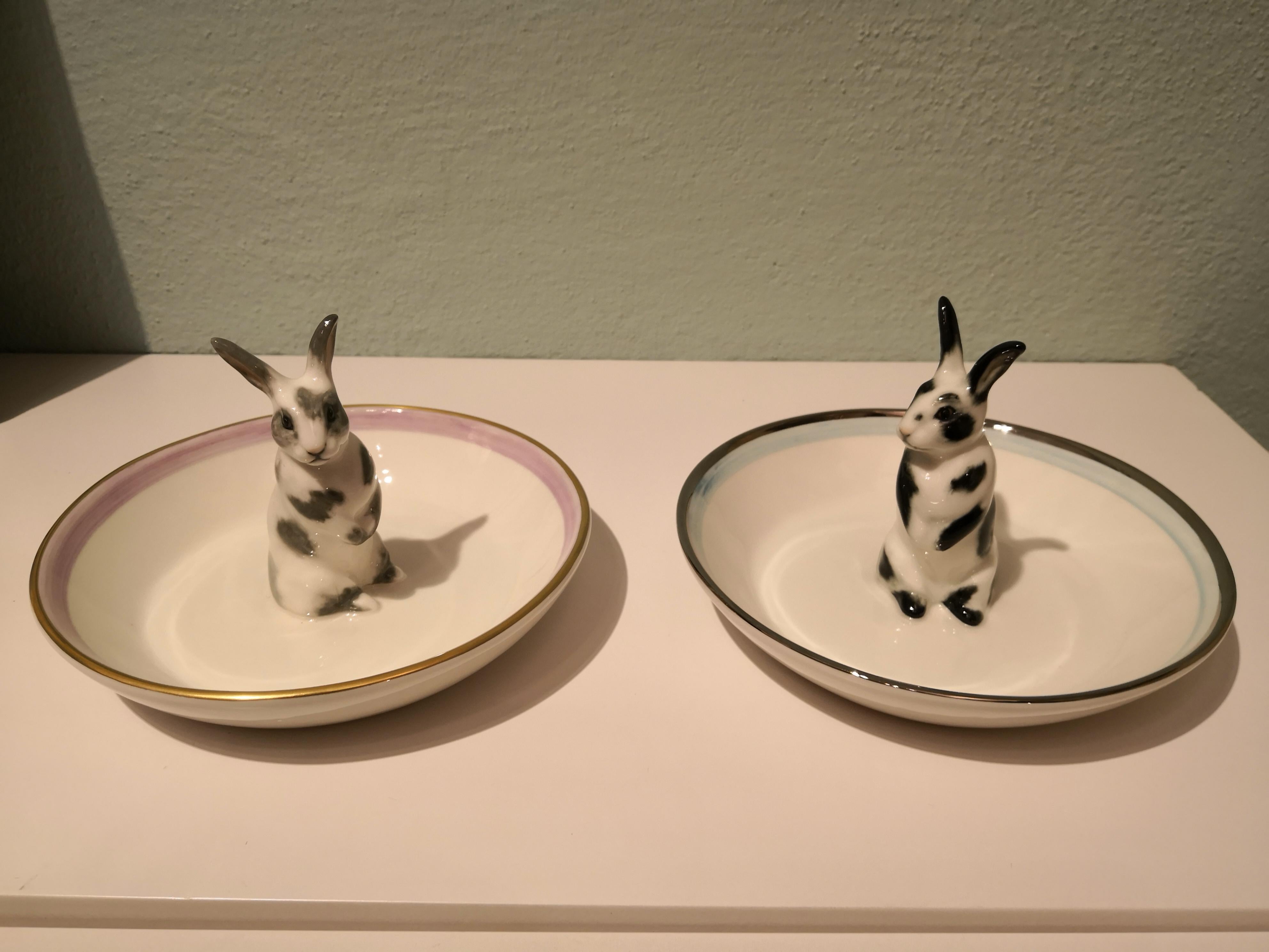 Completely handmade porcelain bowl with a hands-free naturalistic painted hare figure with black spots. The Easter bunny is sitting in the middle of the bowl for decorating nuts or sweets around. Rimmed with a pale blue and platinum line. Handmade