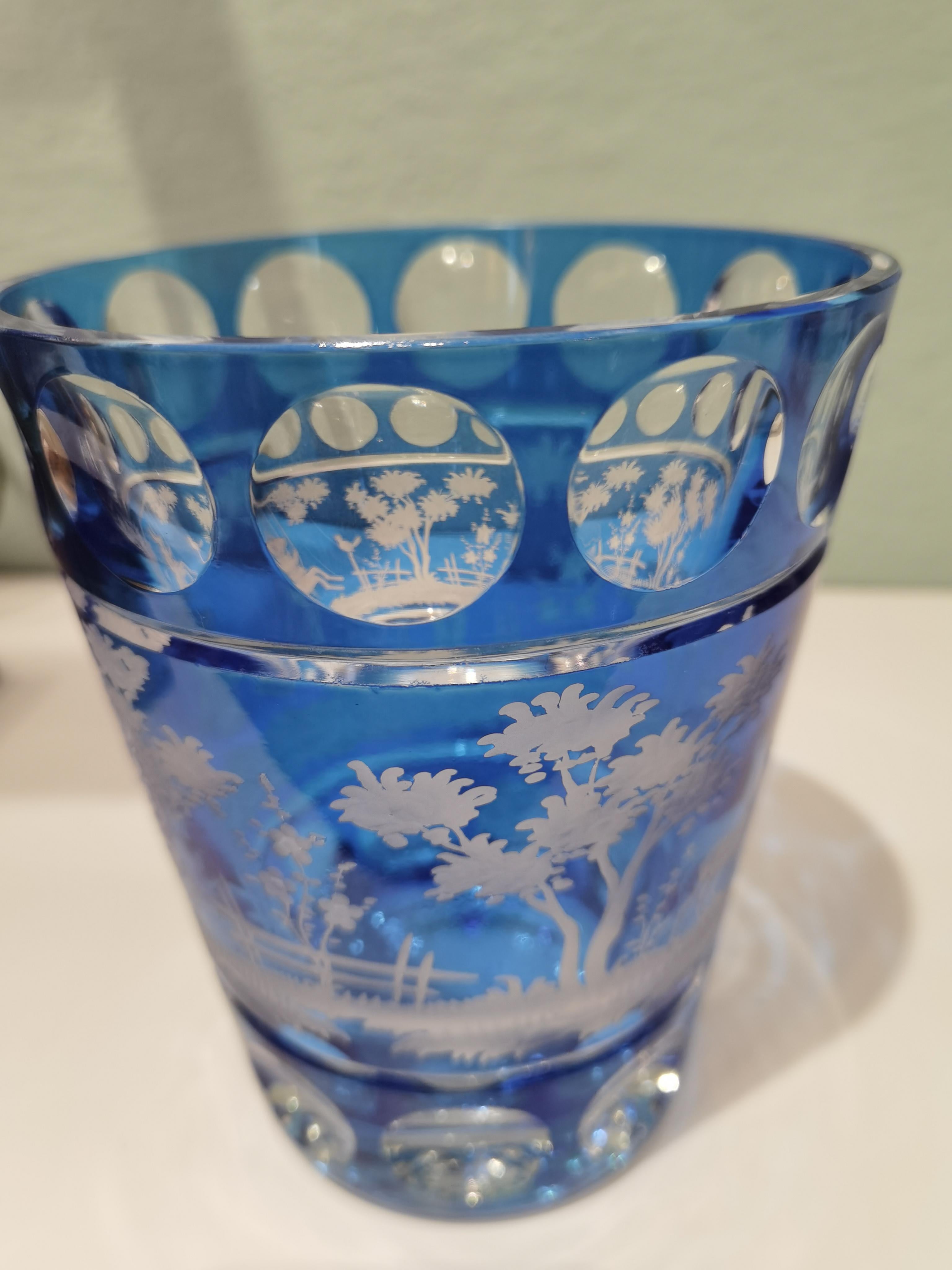 Hand blown crystal vase in blue glass with a country style decor all around. The leaves and deers are hand-engraved by glass artists in Bavaria/Germany. One side shows a bunny and the backside deers. The glass here shown comes in a blue color and