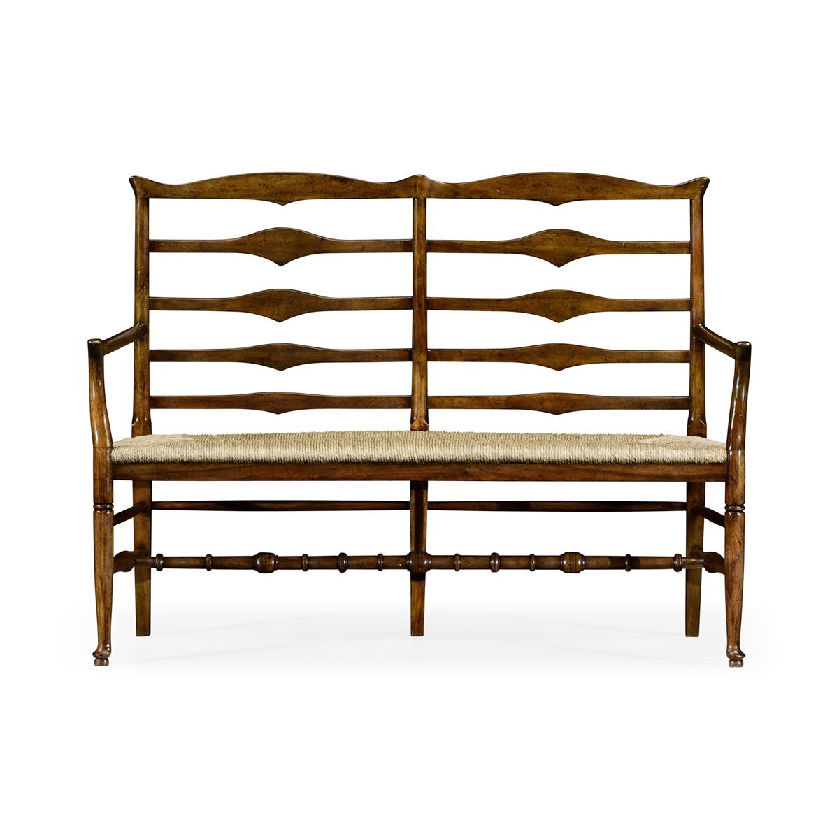 Country style walnut ladder back two seat bench with shaped back rail, graduated ladder slats with triangular shaping in the centre and rush seat. Turned legs and stretchers beneath.

Dimensions: 54.75