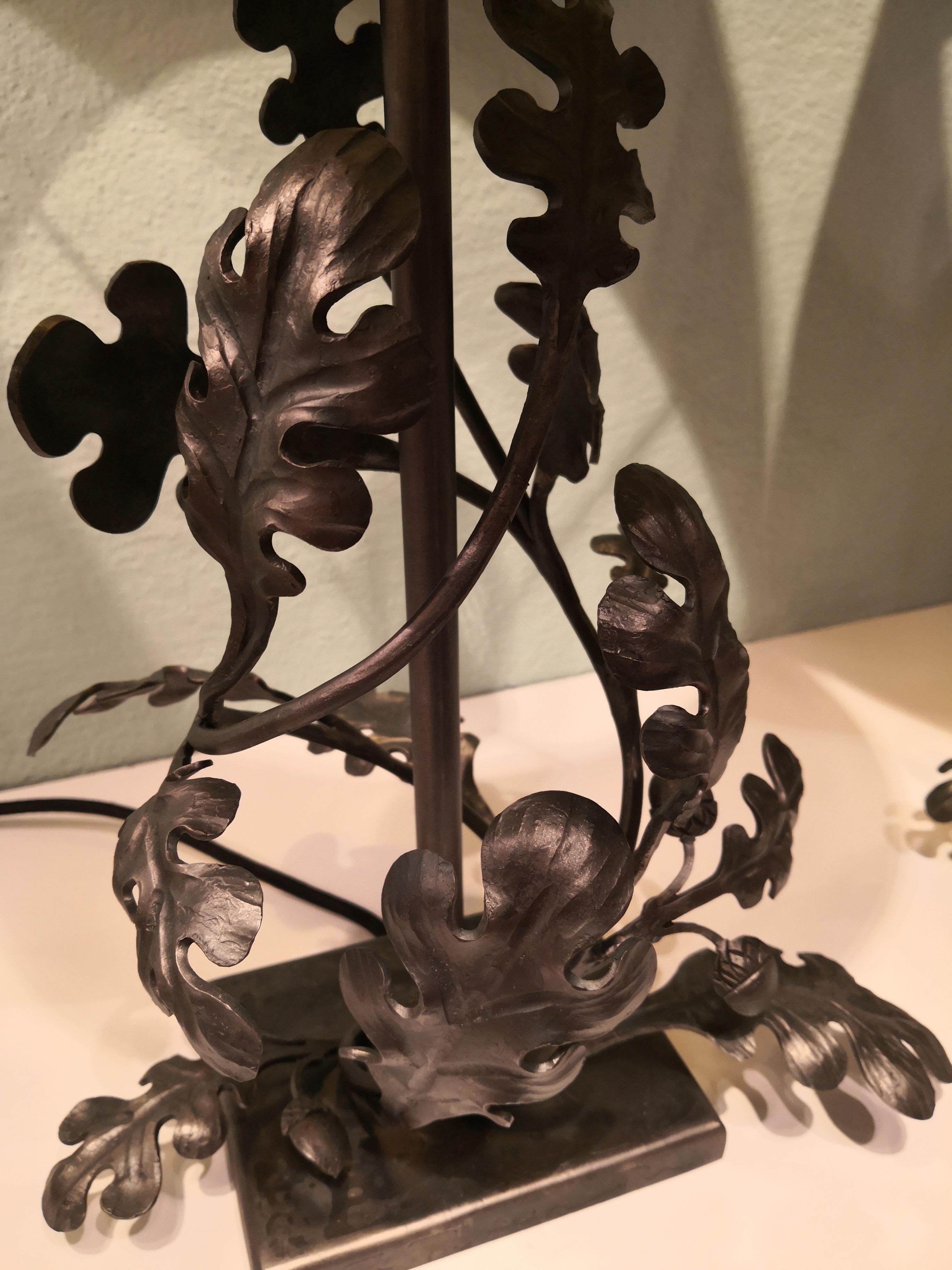 Handmade pair of brushed iron table lamps in the form of sculptural oaks and oak leaves. The lamps are entirely handcrafted by an Austrian blacksmith for Sofina Boutique Kitzbühel. The leaves and oaks are hand forged in iron and brushed. Unglazed