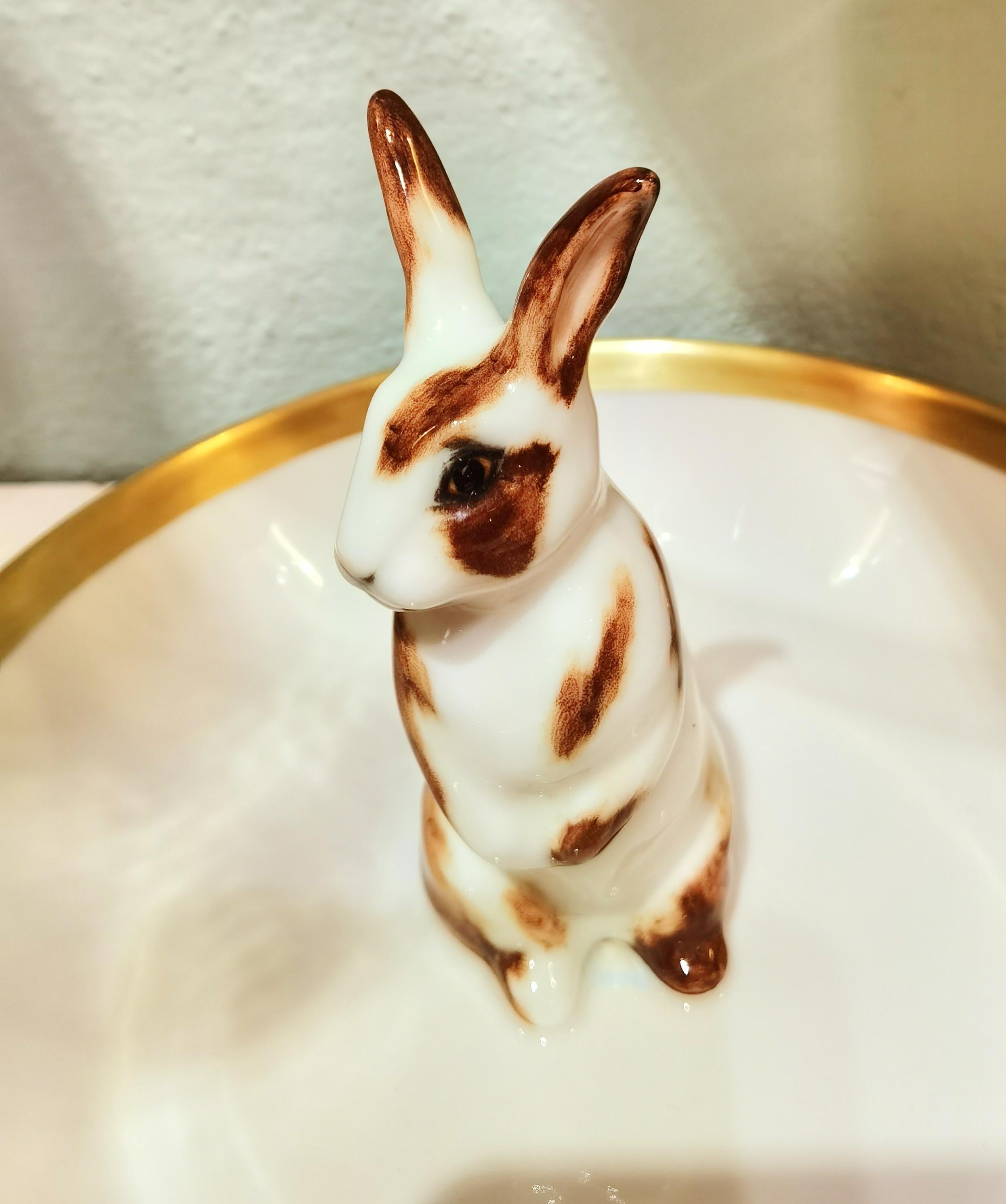 Completely handmade porcelain bowl with a hands-free naturalistic painted Easter bunny figure with brown spots in country style. The bunny is sitting in the middle of the bowl for decorating nuts or sweets around. Rimmed with a 24-carat gold line.