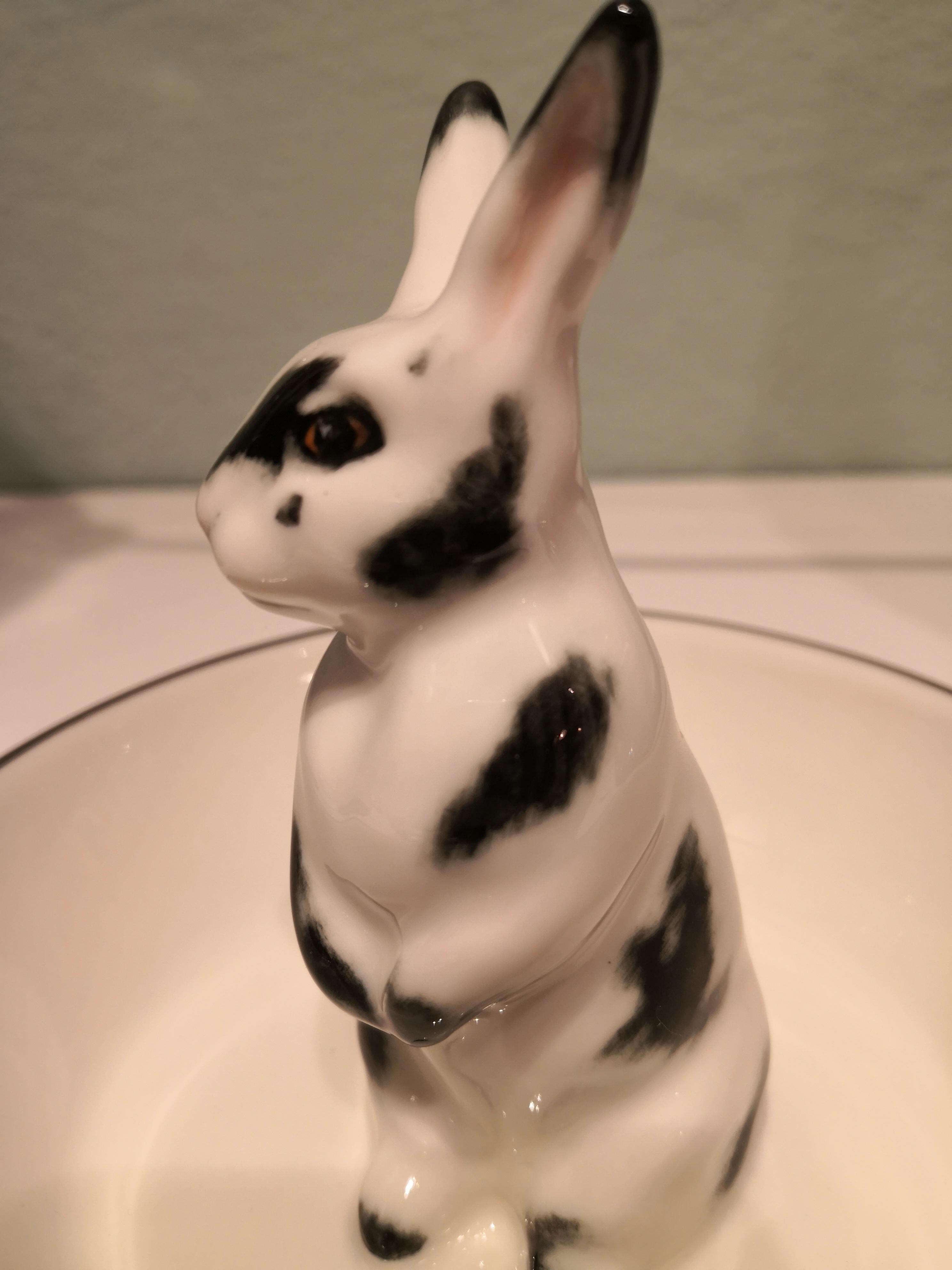 Completely handmade porcelain bowl with a hands-free naturalistic painted Easter bunny figure with black spots in country style. The bunny is sitting in the middle of the bowl for decorating nuts or sweets around. Rimmed with a platinum line.