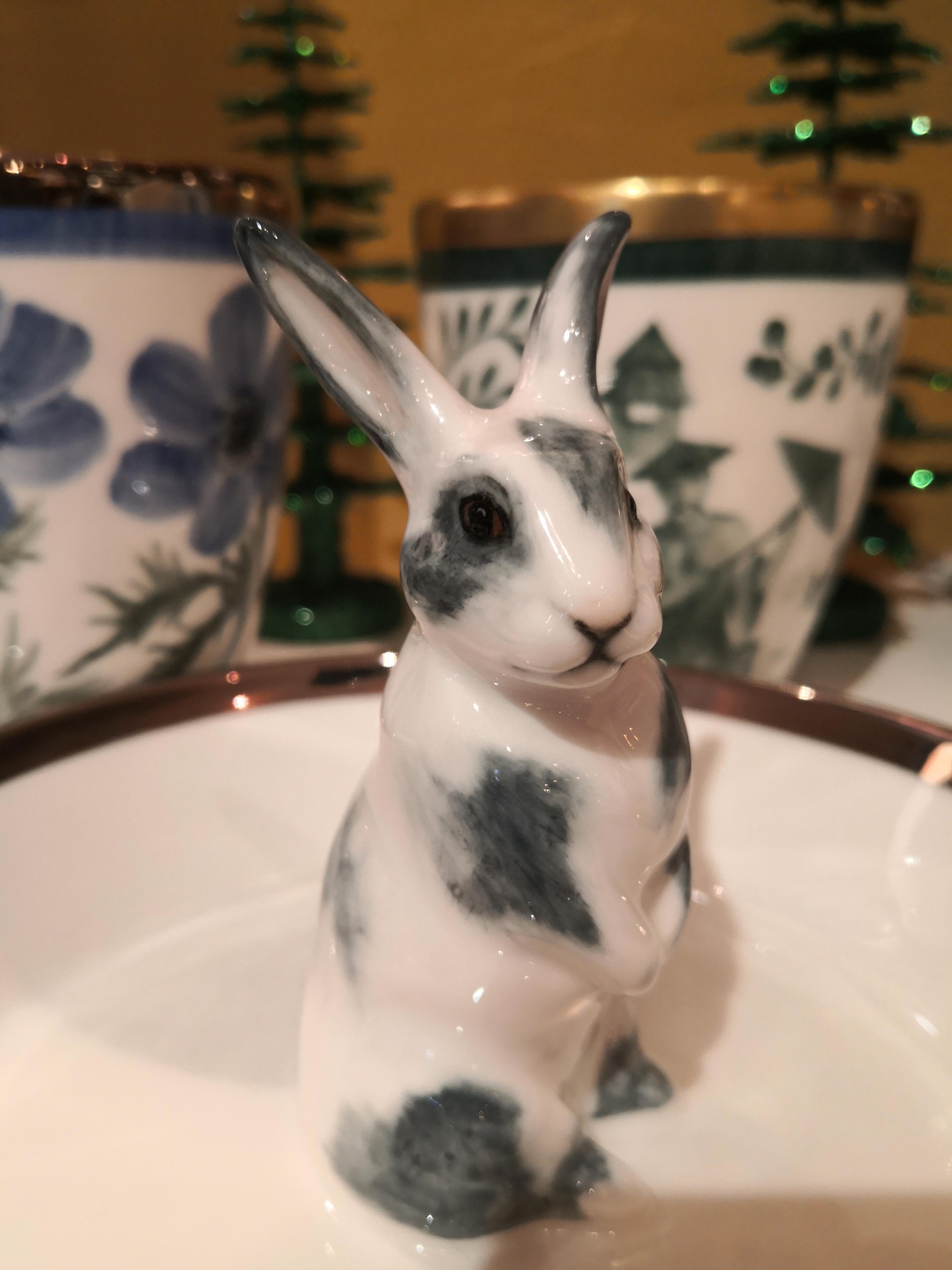 Completely handmade porcelain bowl with a hands-free naturalistic painted bunny figure with grey spots in country style. The bunny is sitting in the middle of the bowl for decorating nuts or sweets around. Rimmed with a platinum line. Handmade in
