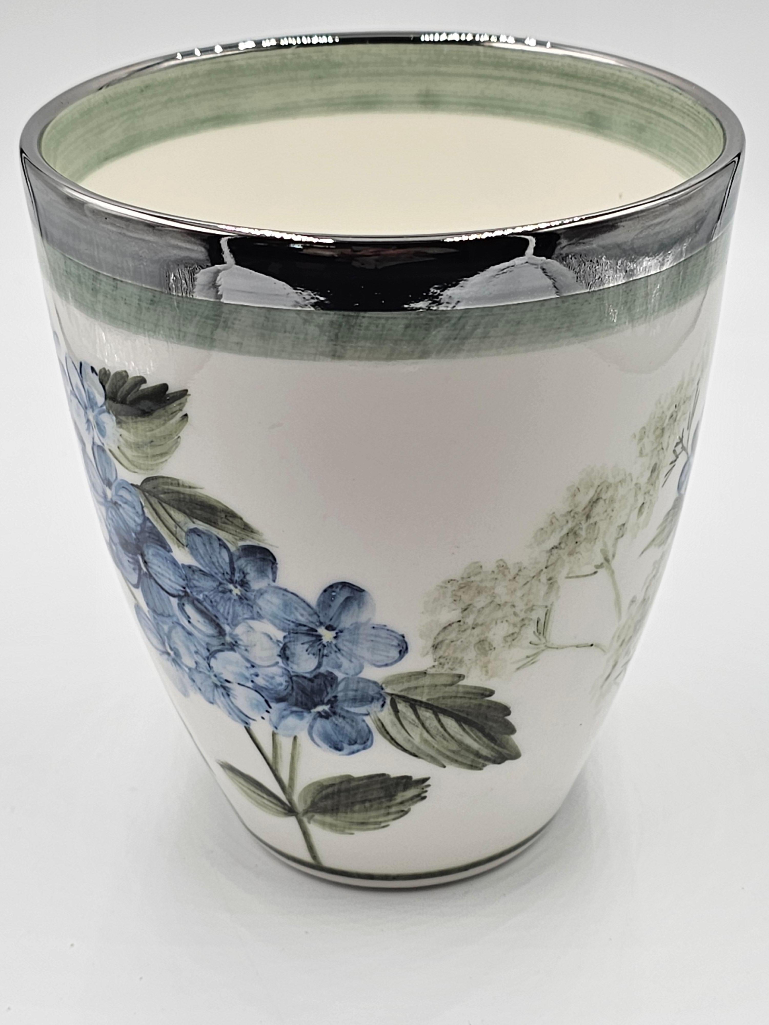 Hands-free painted porcelain vase with a flower decor all around. Rimmed with a platinum rim. Completely made by hand in Bavaria/Germany with a exclusive decor hydrangea in blue color for Sofina Boutique Kitzbühel.
Looks beautiful with fresh flowers