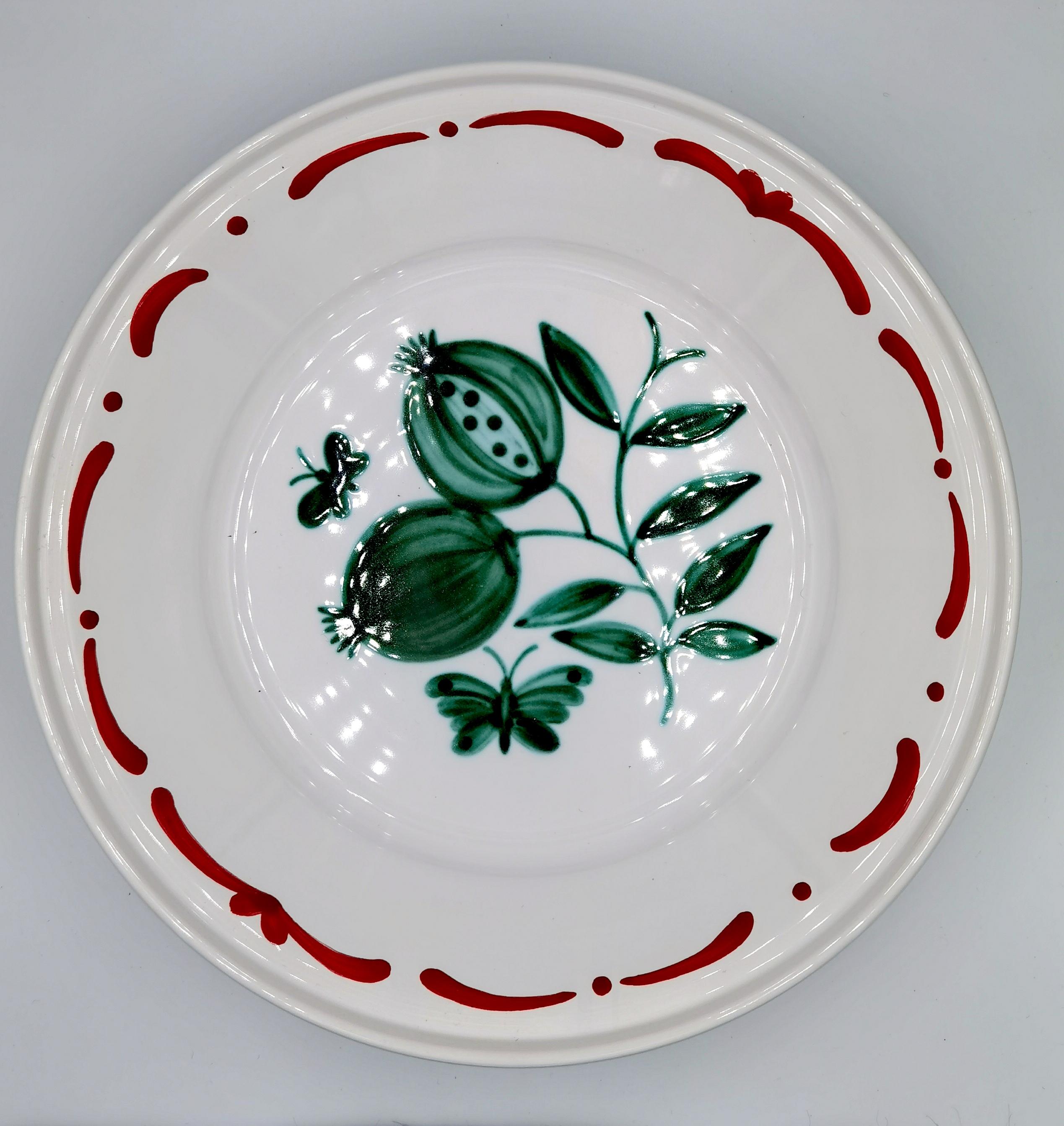 Large hands-free painted pottery dish in country style. Decorated with a handpainted green pomegranate decor in the center with butterflies and a hands-free painted garlande . The garlande can be ordered in different colors. Produced and handsfree