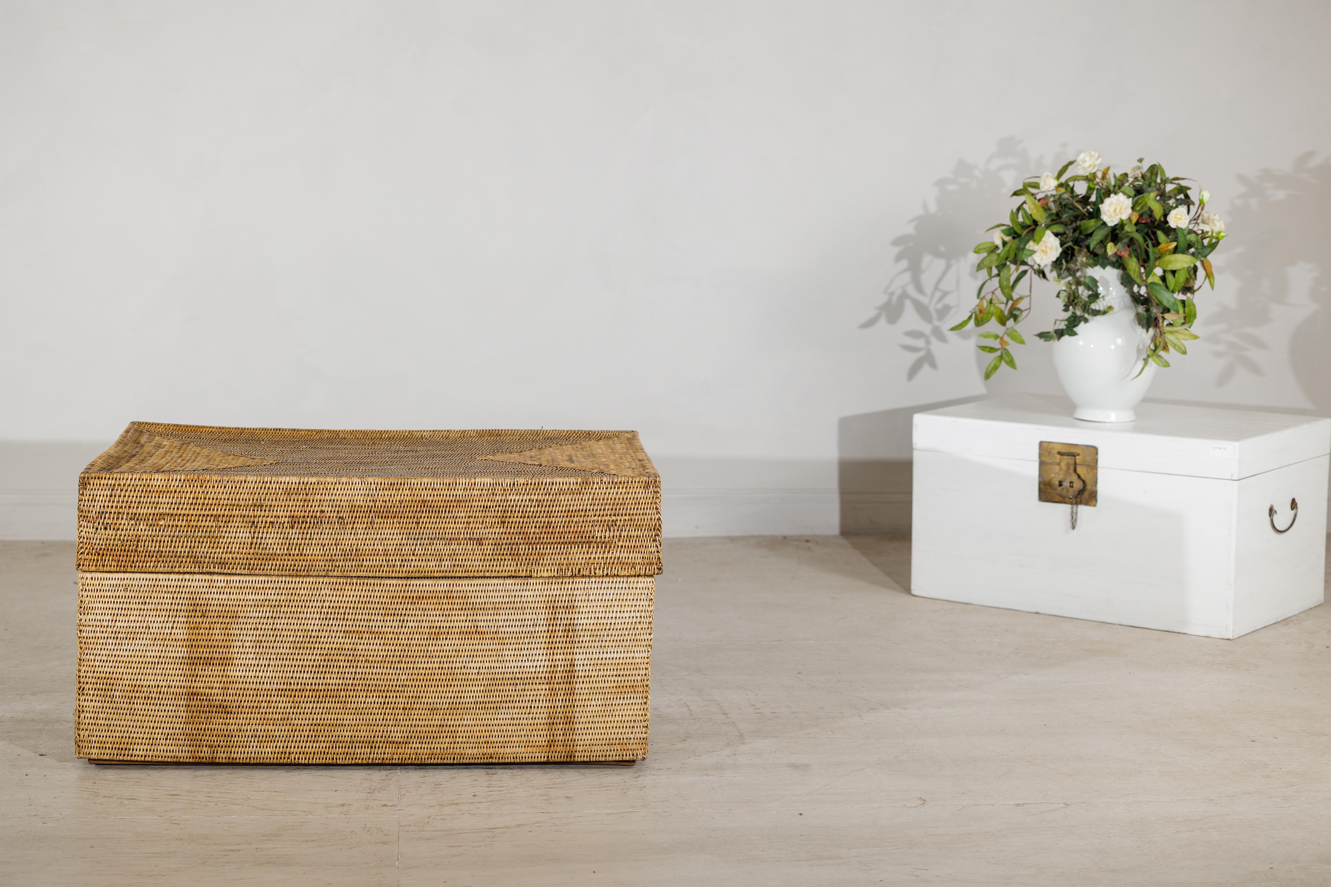 This vintage rectangular coffee table is crafted in tightly woven natural rattan, offering both warmth and practicality in a single, versatile piece. The clean, linear silhouette is softened by the subtle texture of the handwoven surface, giving the