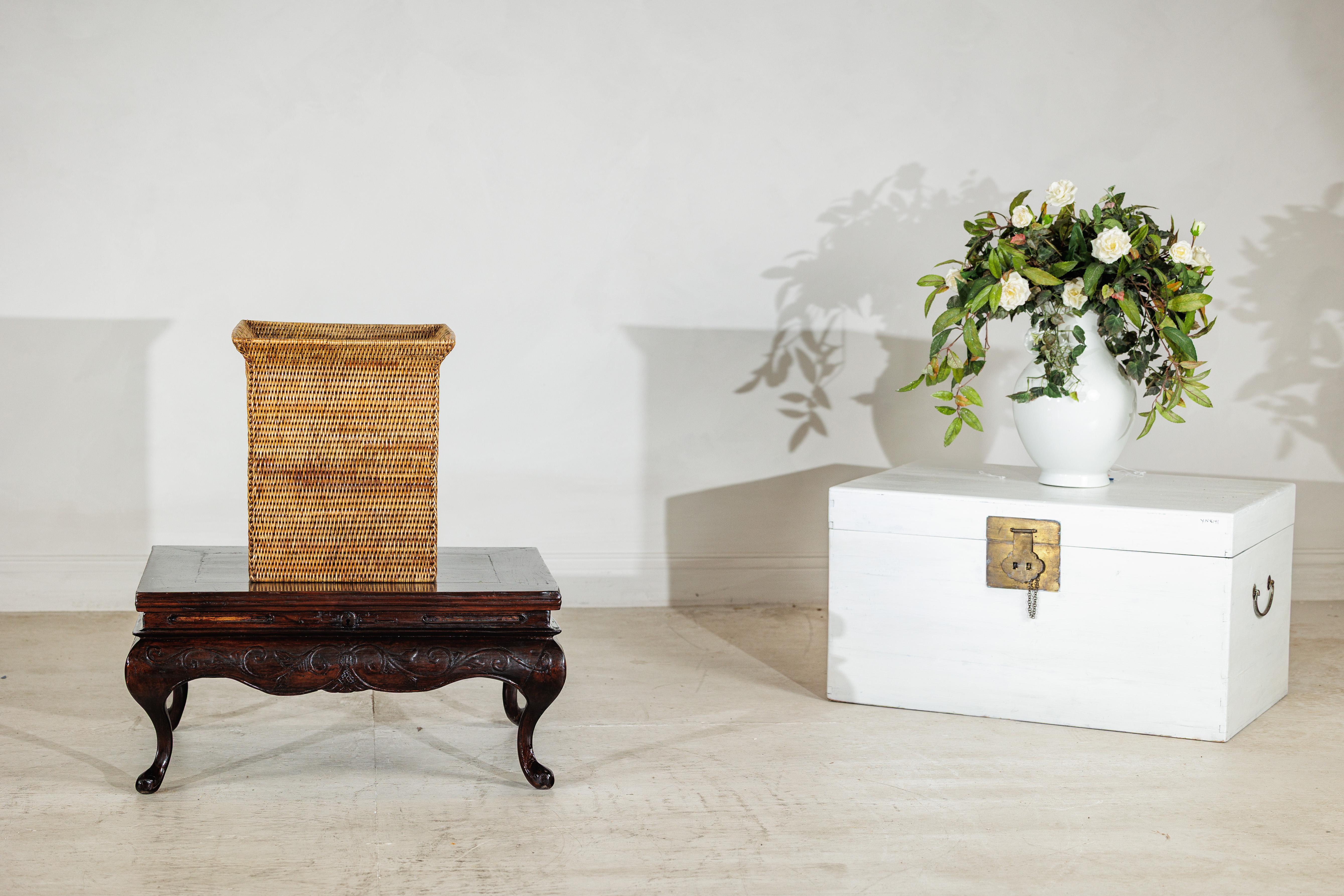 A square vintage rattan basket handwoven with tight, even strands and finished with a subtle natural sheen. Its design combines structure and softness — the sides taper slightly inward toward the base, while the wide flared rim gives it an elegant,