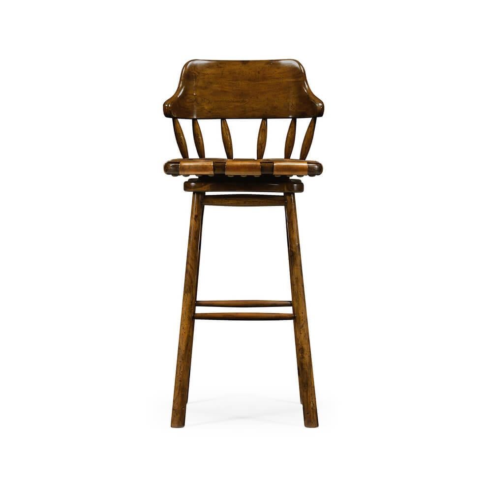 Country style walnut bar stool with a curbed solid backrest supported by turned spindles, above a webbed antiqued leather revolving sear and raised on tapered legs with a stretcher base.

Dimensions: 19.5