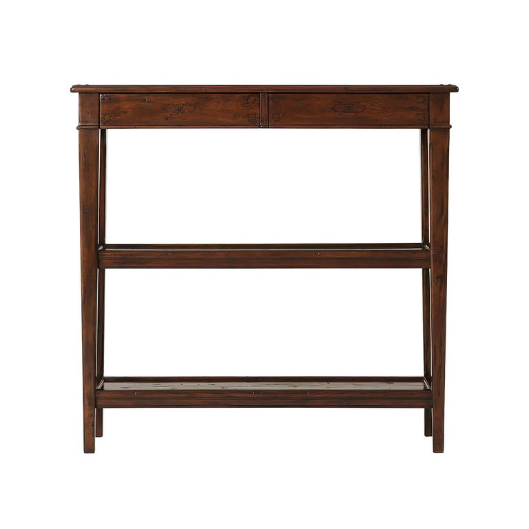 A French Provincial Neo Classic antiqued wood console table, with two frieze drawers and two further tiers between square tapering supports. 

Dimensions: 37.75