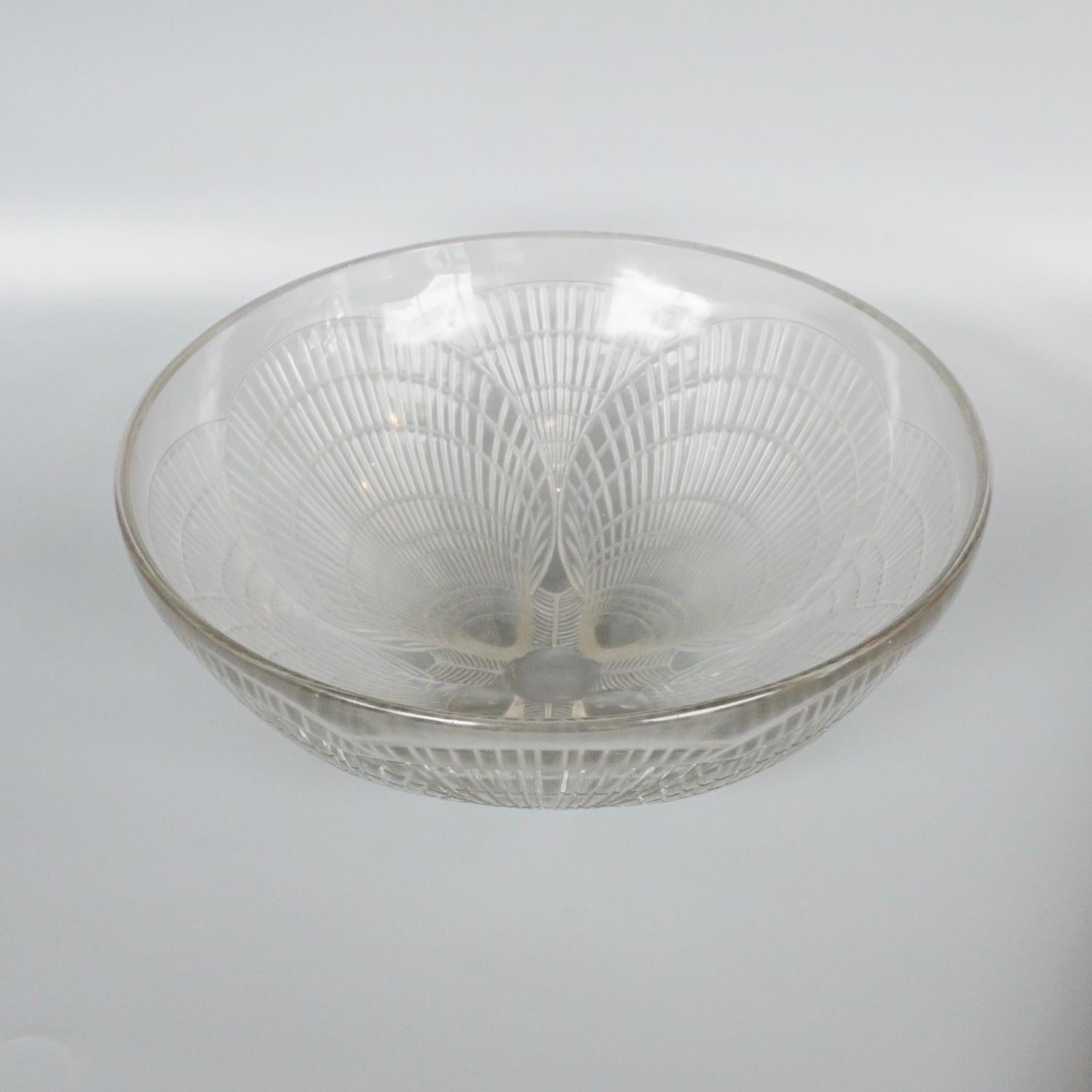 Coupe Coquilles, an Art Deco, clear glass bowl by René Lalique. Covered over with raised, geometric motif of scallop shells.

Etched R Lalique France to centre of bowl. 

Literature: Marcilhac, R Lalique Catalogue Raisonné de L’Œuvre de Verre