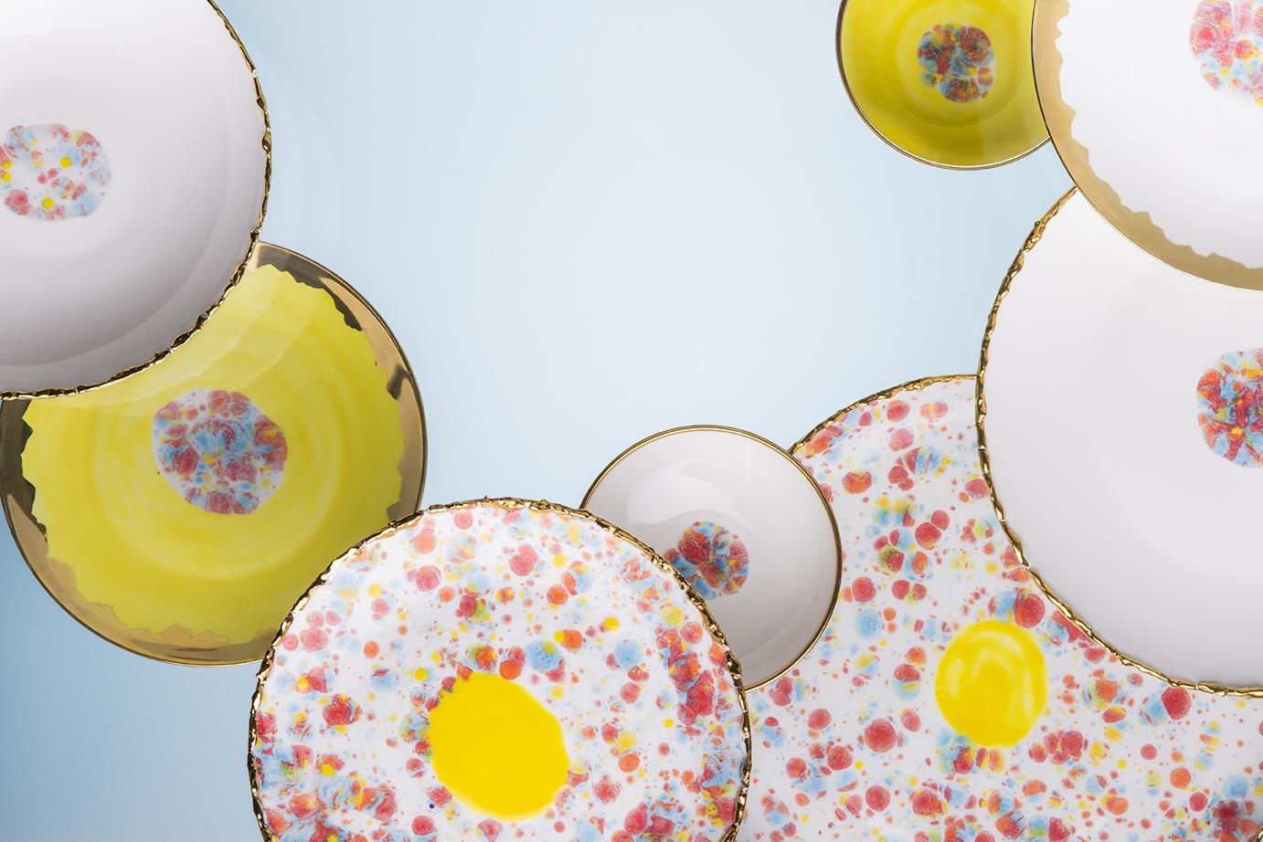 Hand painted in Italy from the finest porcelain, this craquelé edge coupe platter from the Confetti collection has an original golden crackled rim emphasizing the lively multi-color dotted enamel and the yellow decoration at the center.

Craquelé